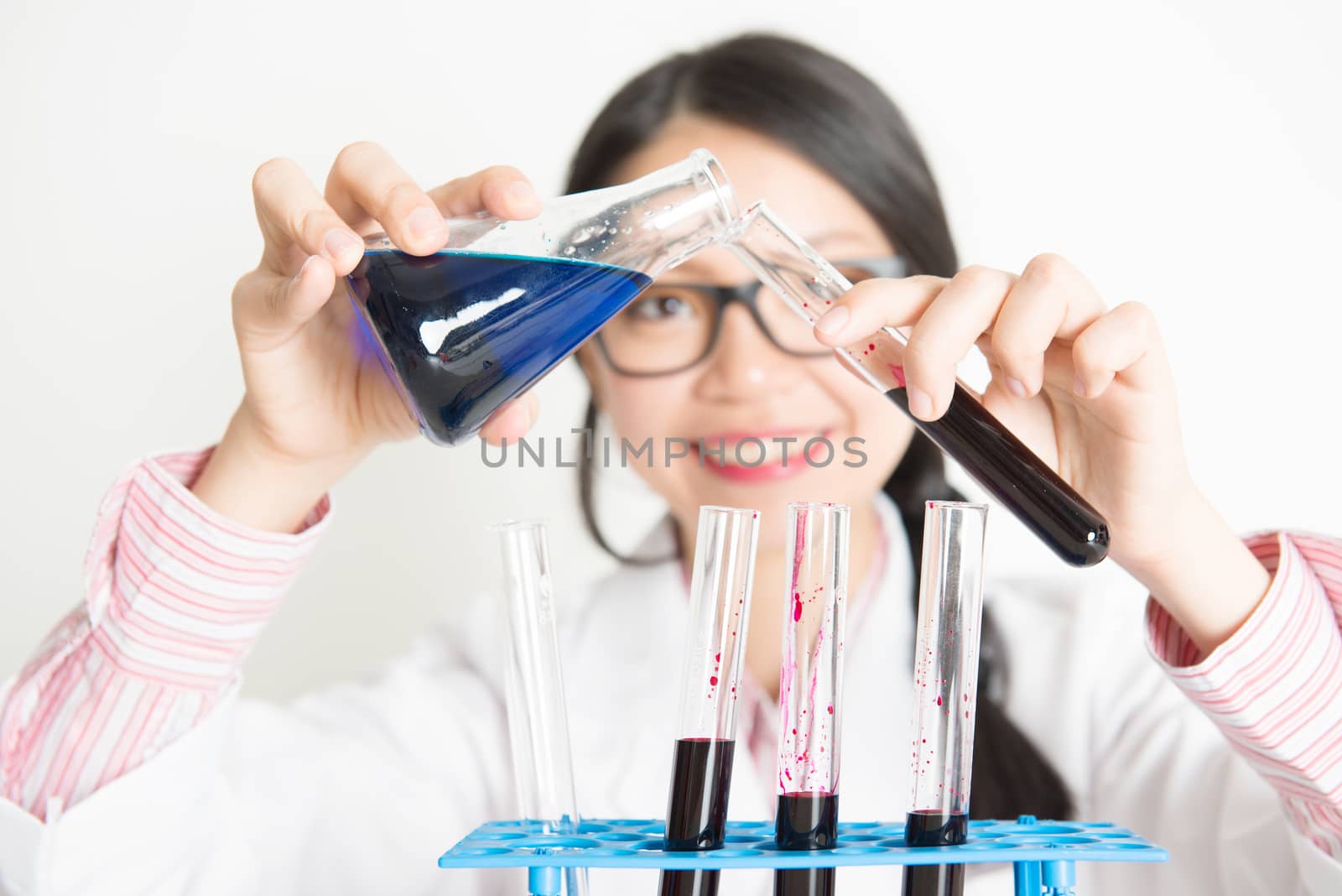 Young female scientist doing experiment in lab by szefei