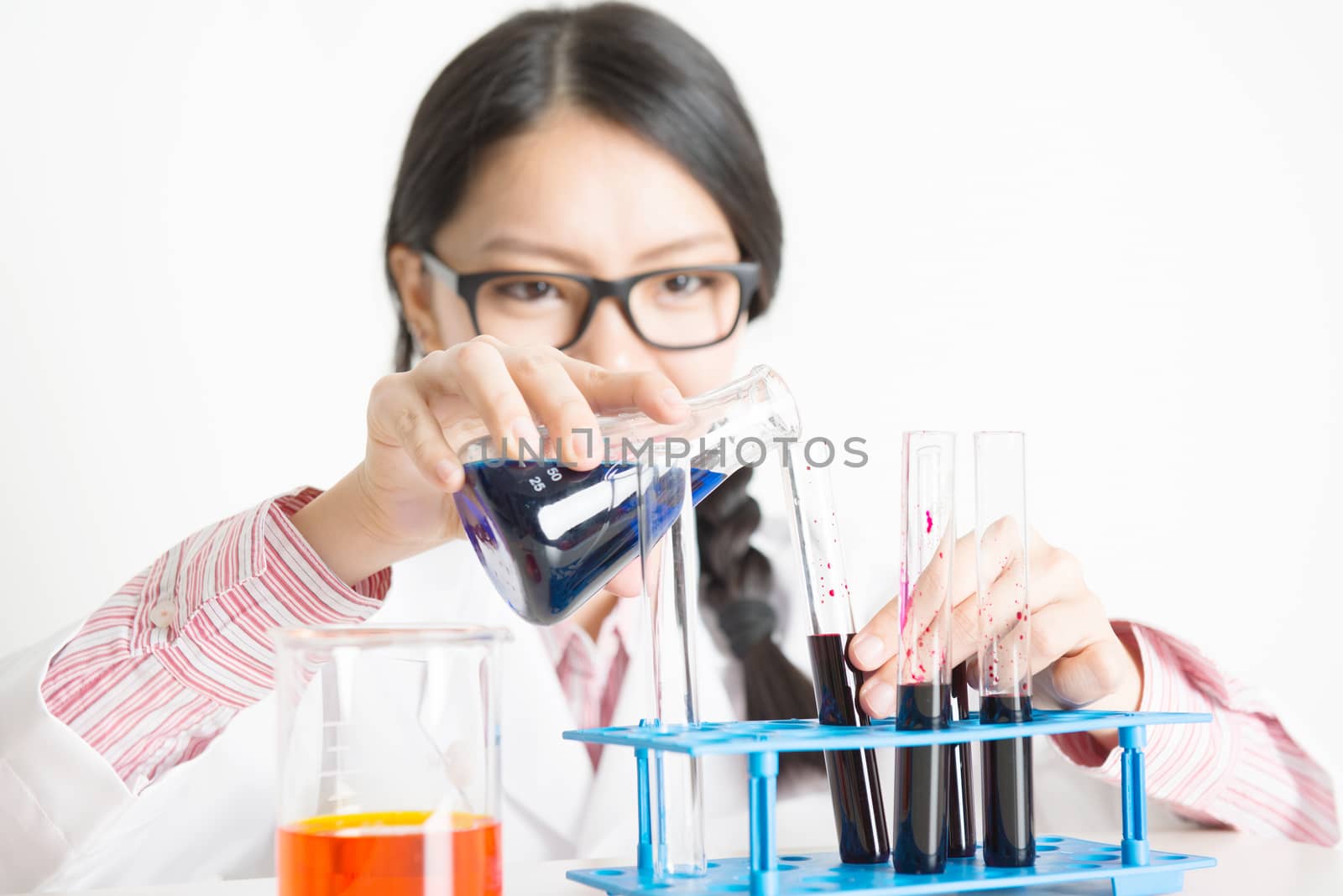 Young Asian female scientist doing experiment in lab by szefei