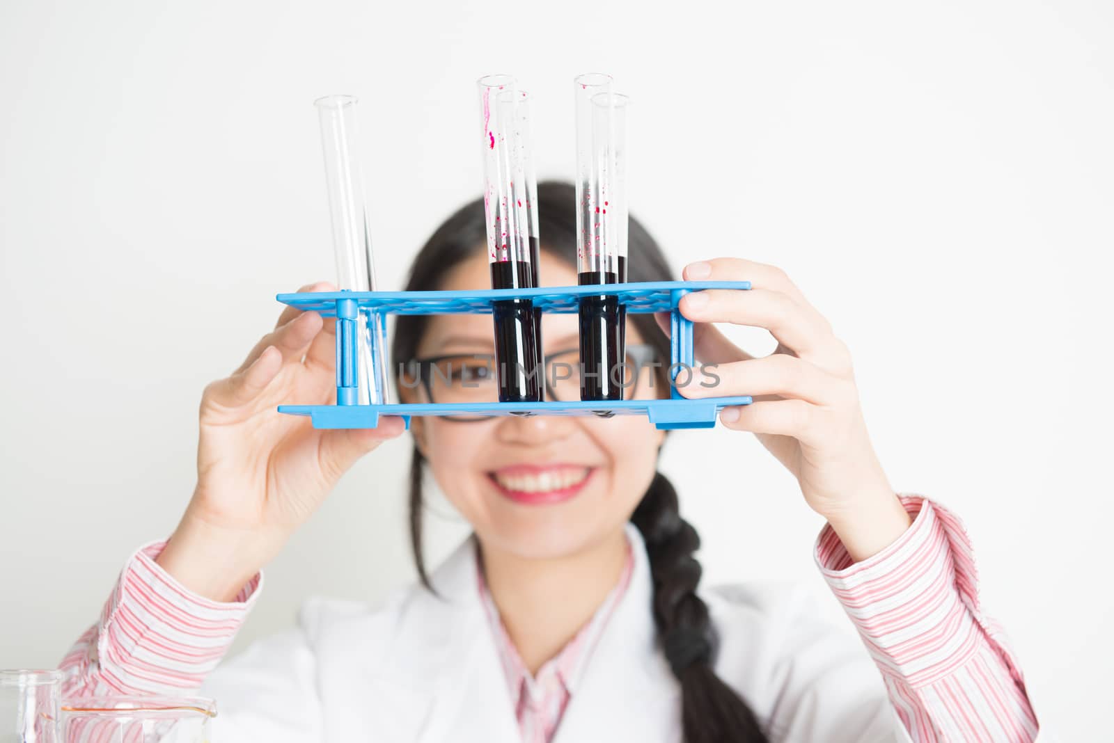 Young Asian female scientist carrying out scientific research  by szefei