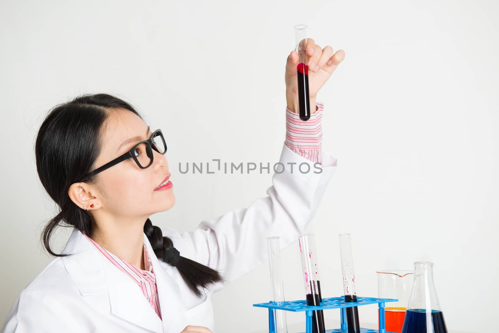 Portrait of young woman scientists doing experiment in the lab with chemistry liquid.