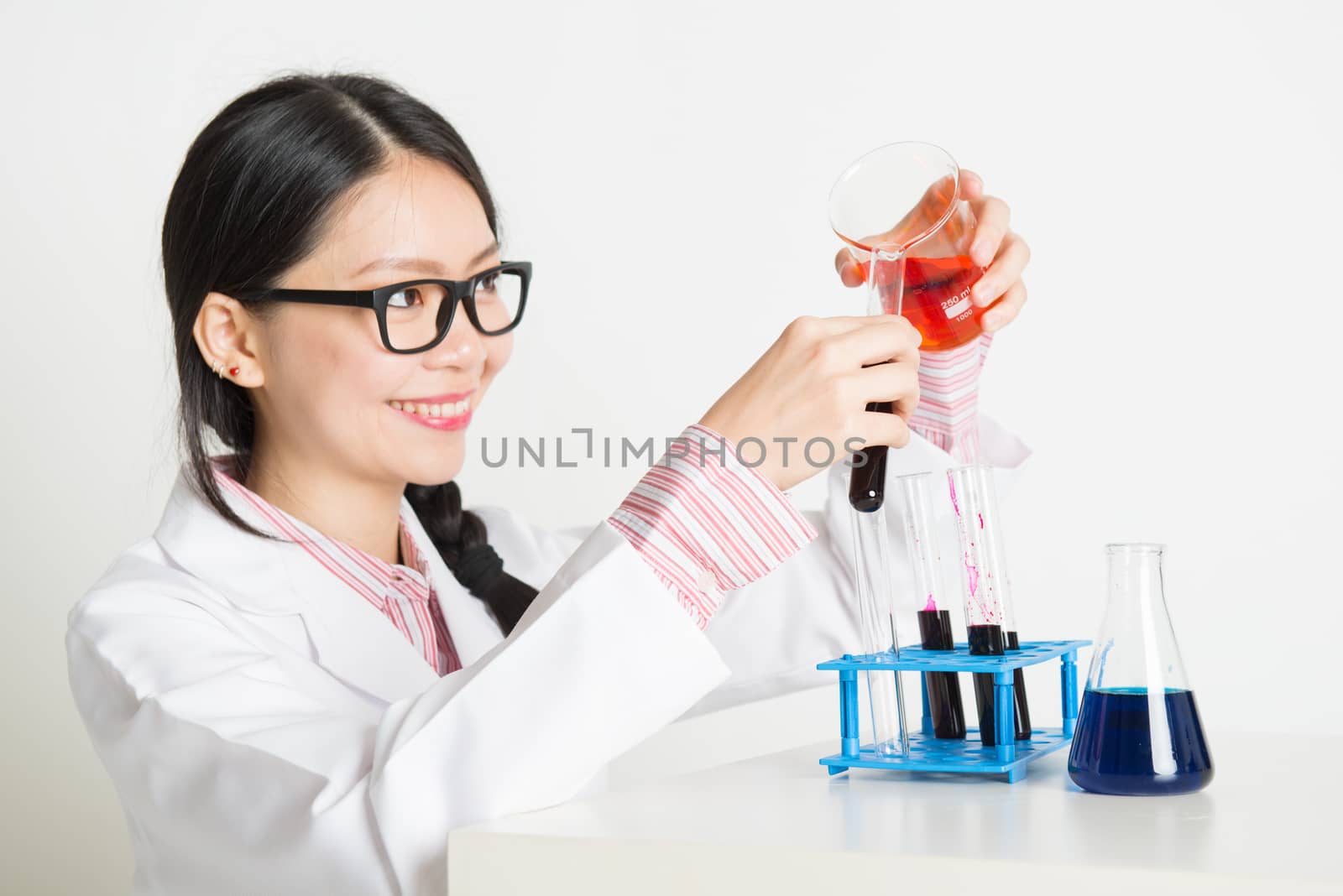 Portrait of smart and young Asian scientists doing experiment in the lab with chemistry liquid