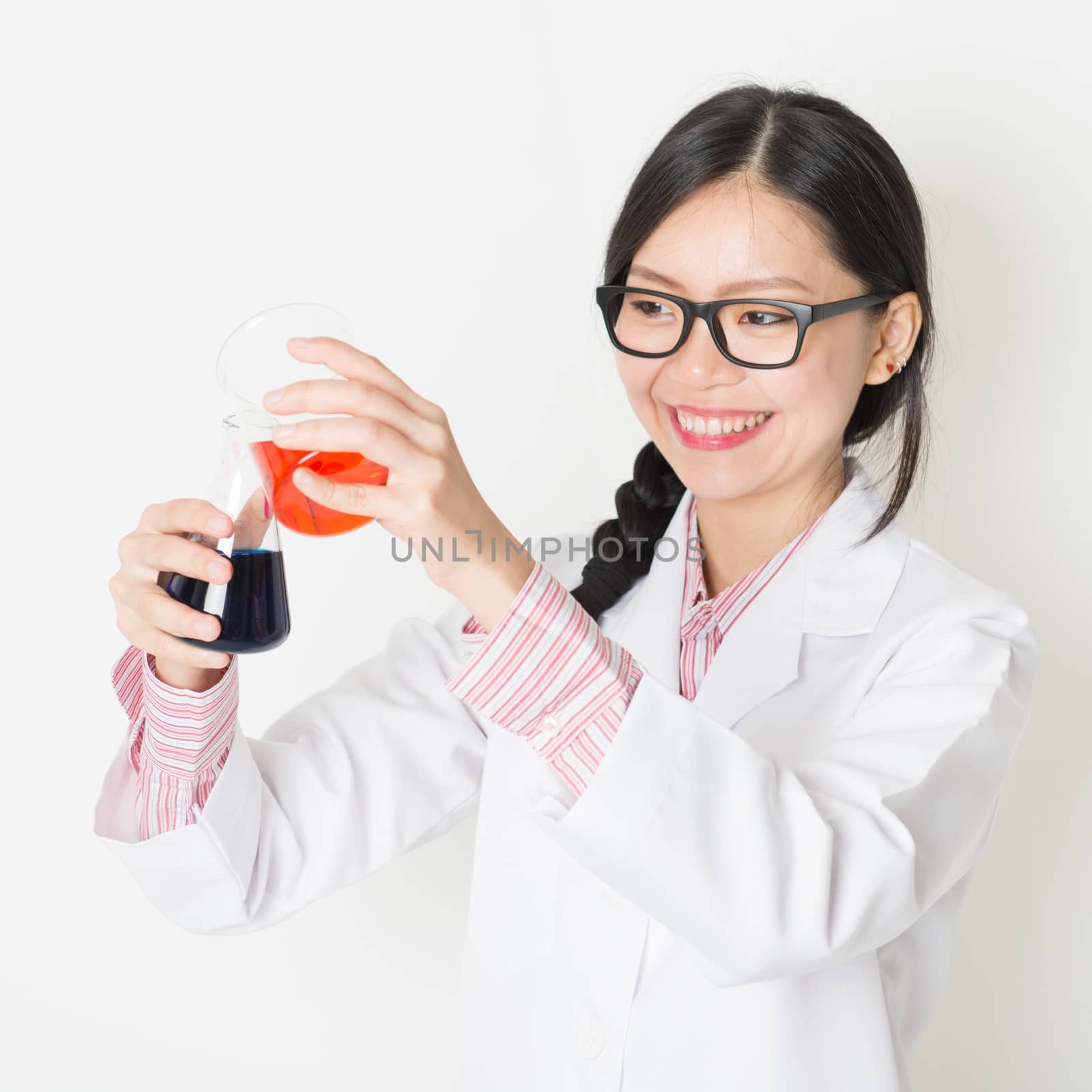 Young Asian Chinese female student in microbiological class. Research in science laboratory.