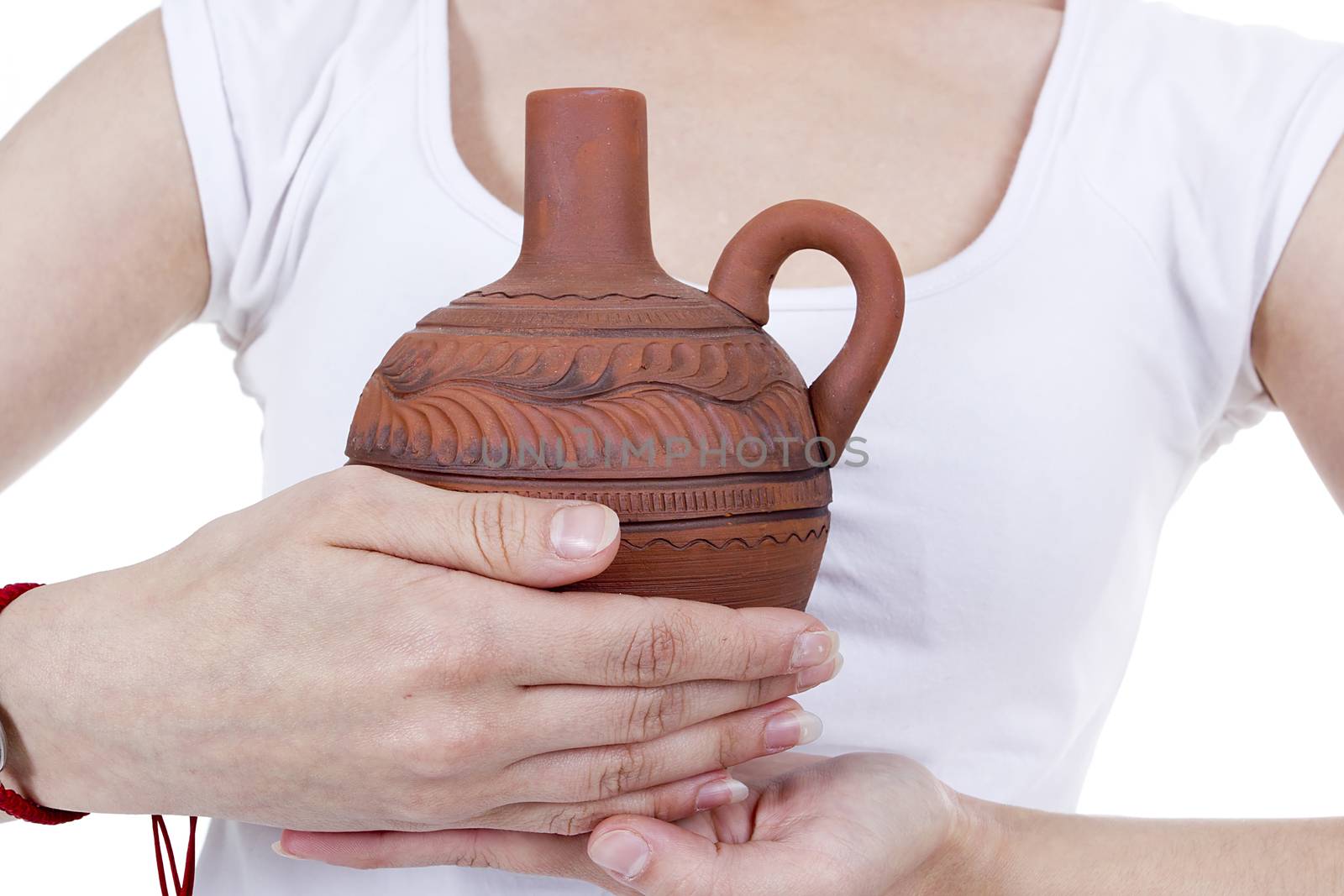Clay pitcher in female hands by VIPDesignUSA