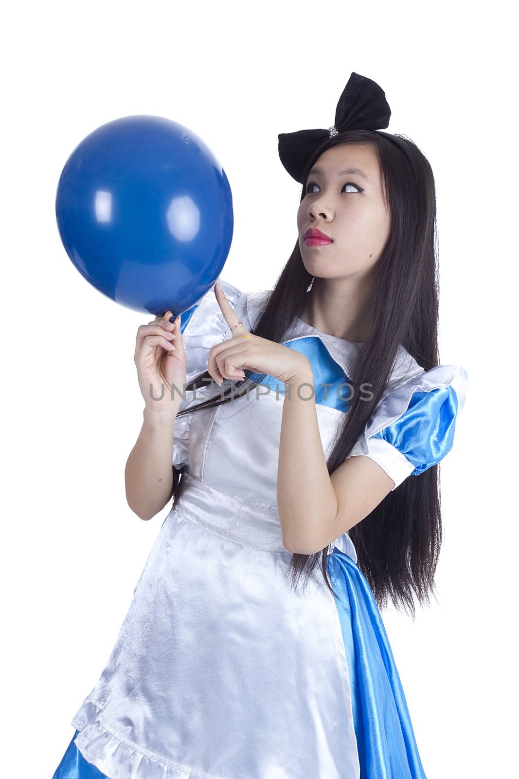 Young girl in the image of Alice with blue ball