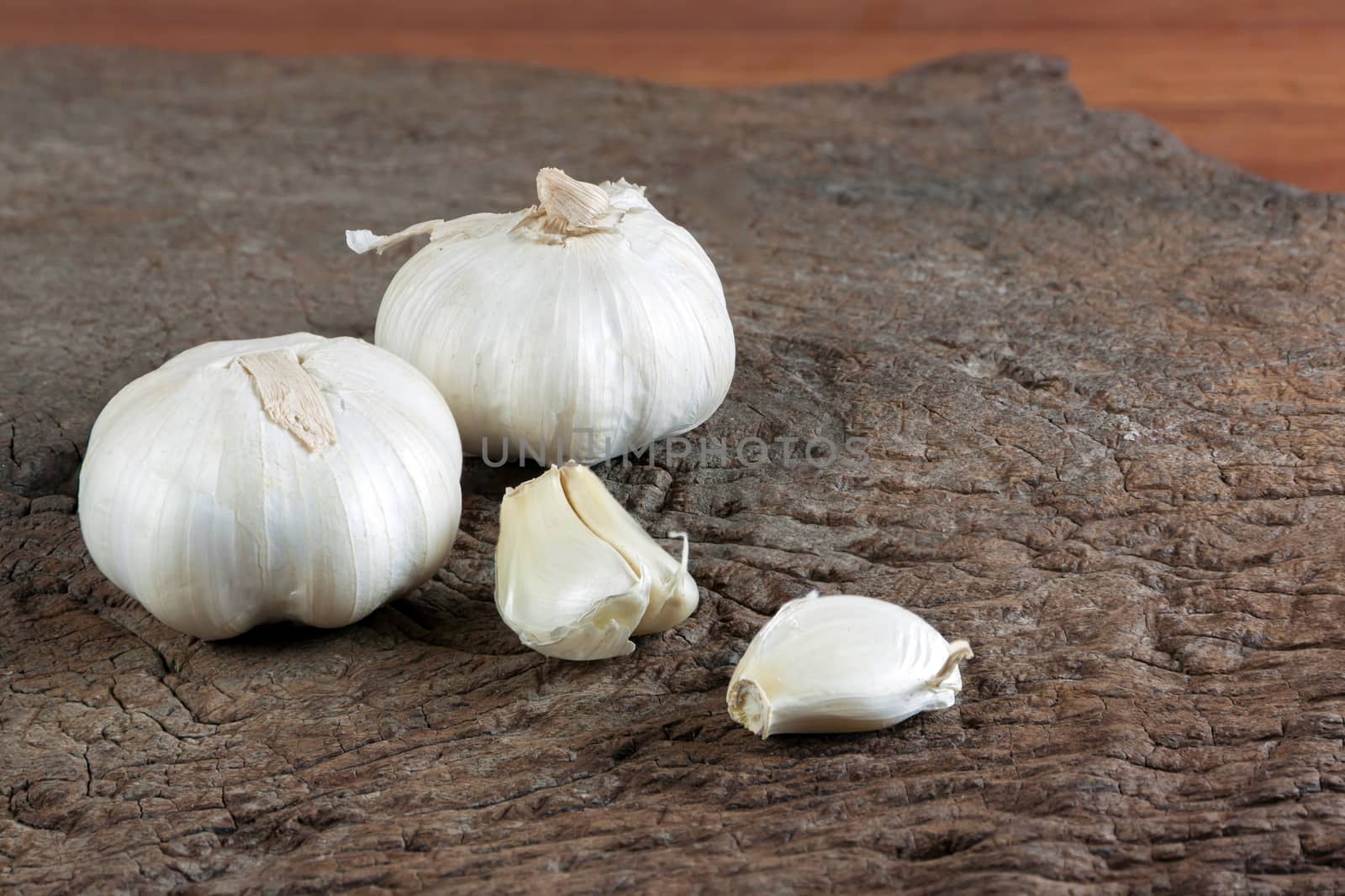 Garlic cloves on a vintage wooden background.