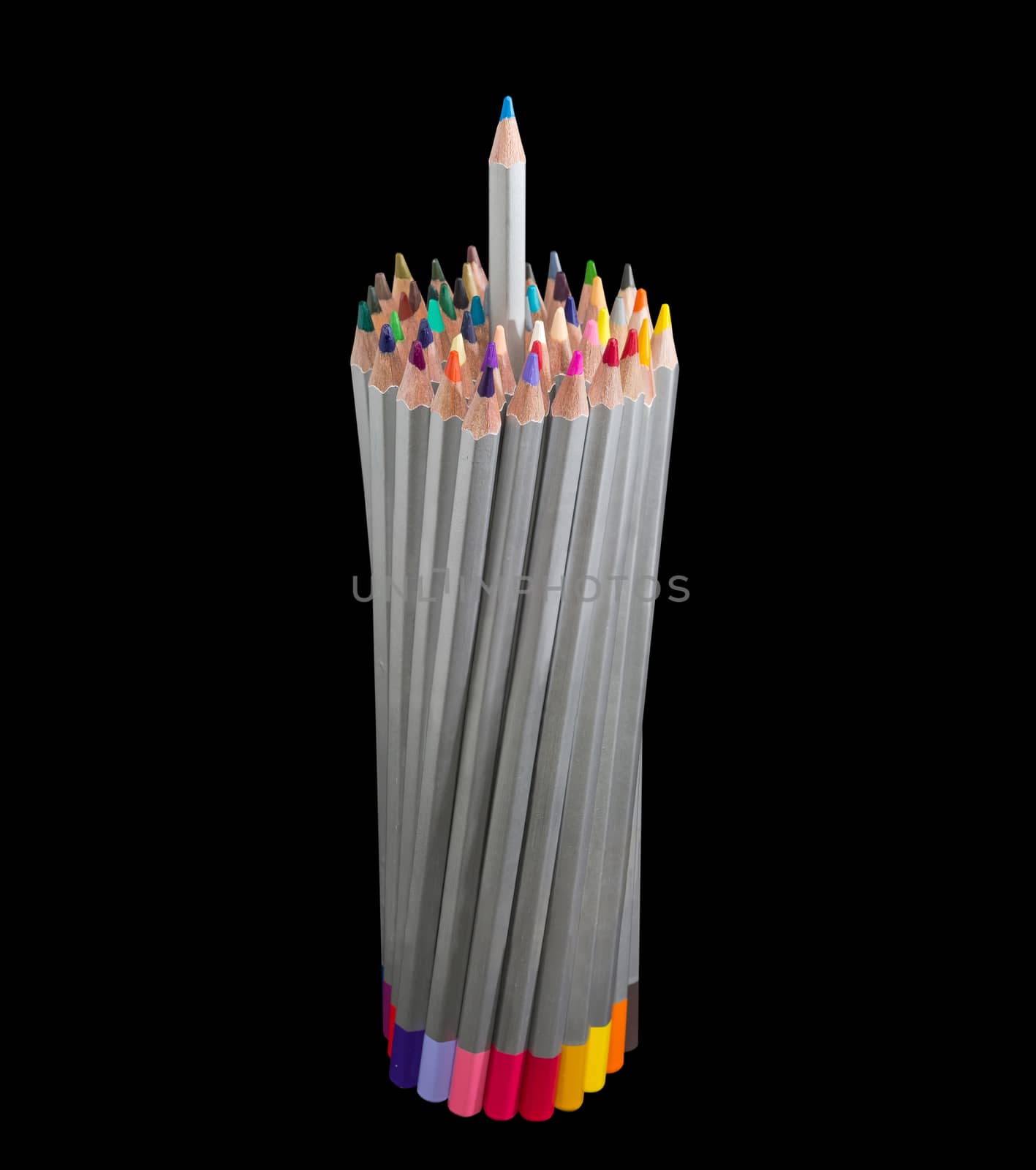 Bunch of colored pencils in gray wooden case with one blue pencil partly pull out on a dark background
