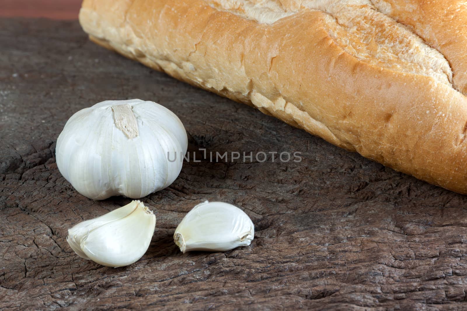 Garlic cloves on a vintage wooden background.