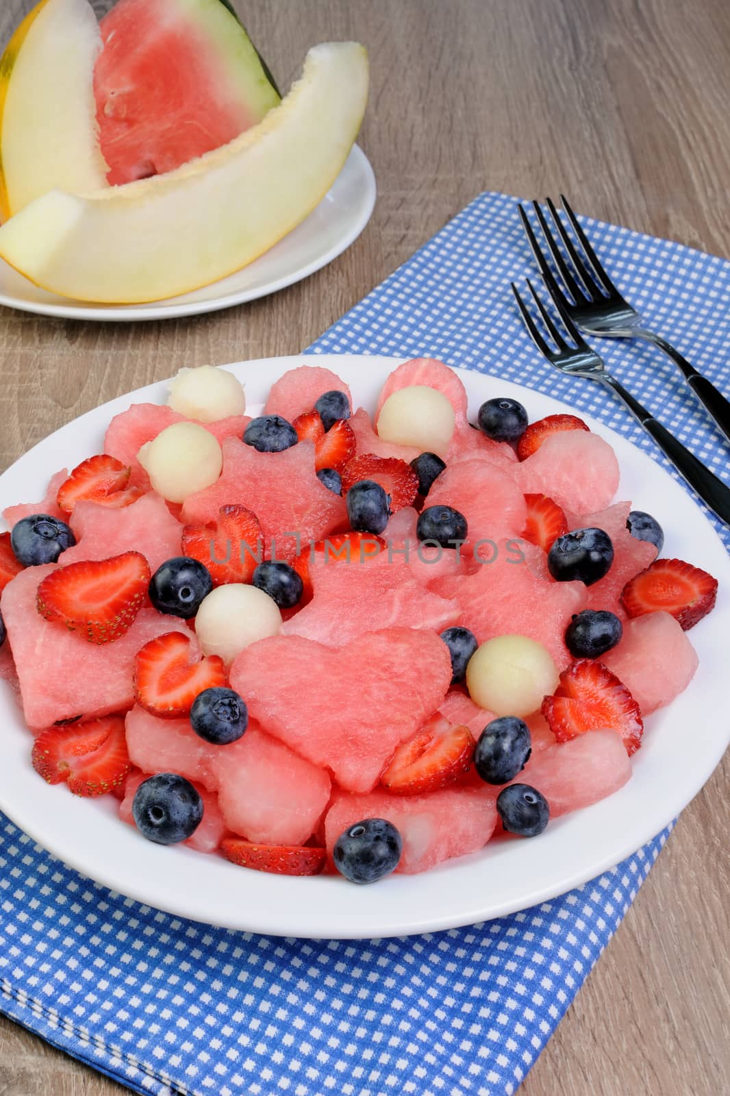fruit salad of blueberries, watermelon hearts, stars, balls of melon and strawberries