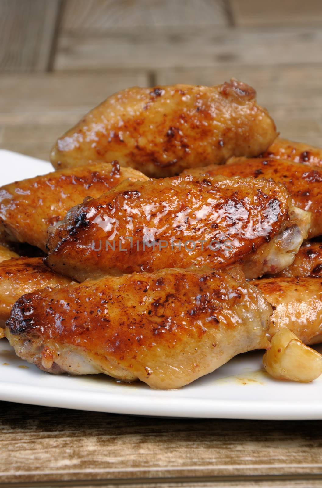 Fried sharply spicy chicken wings on a plate
