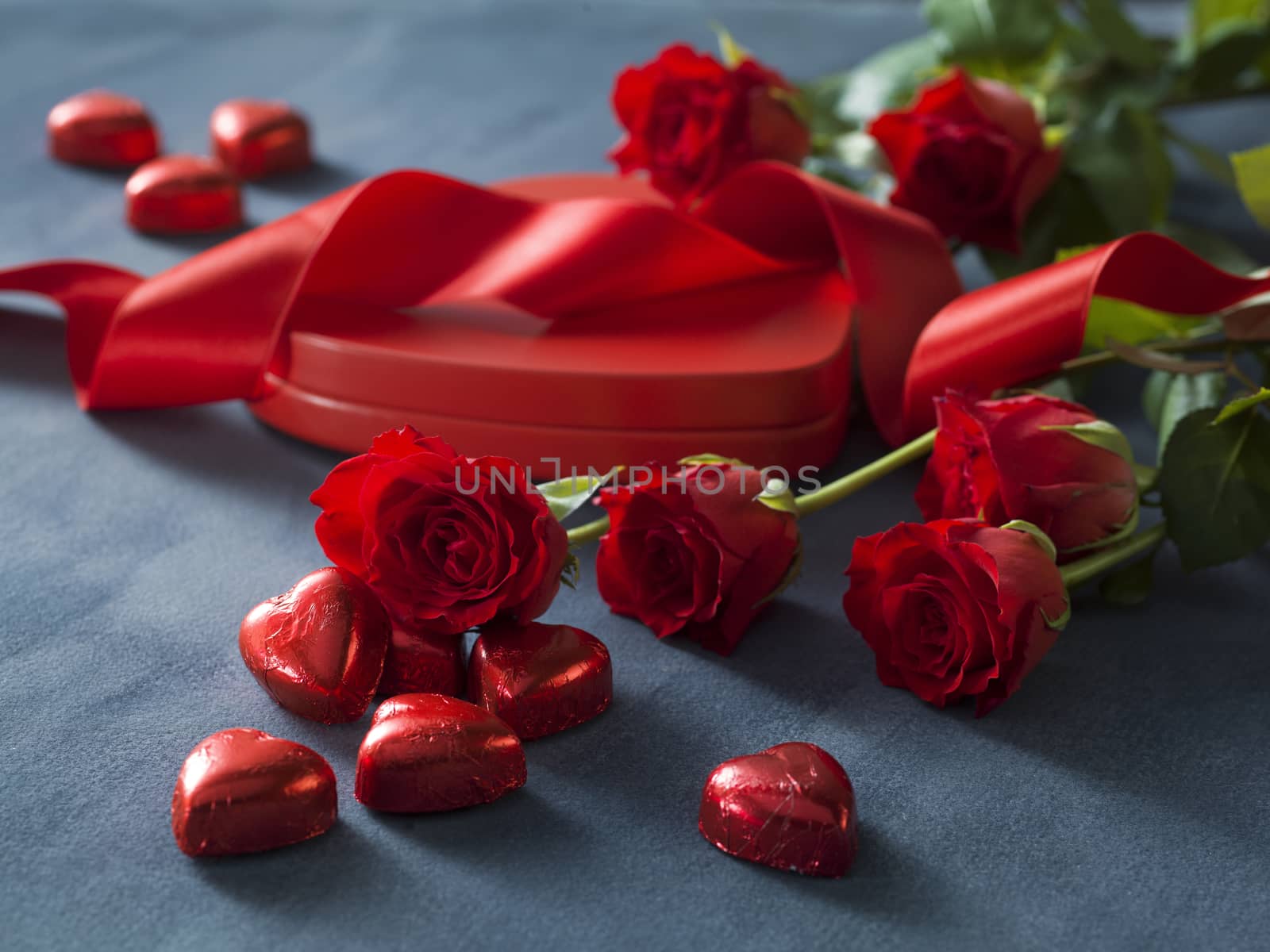 Bunch of red roses and box with red hearts. Valentines Day concept