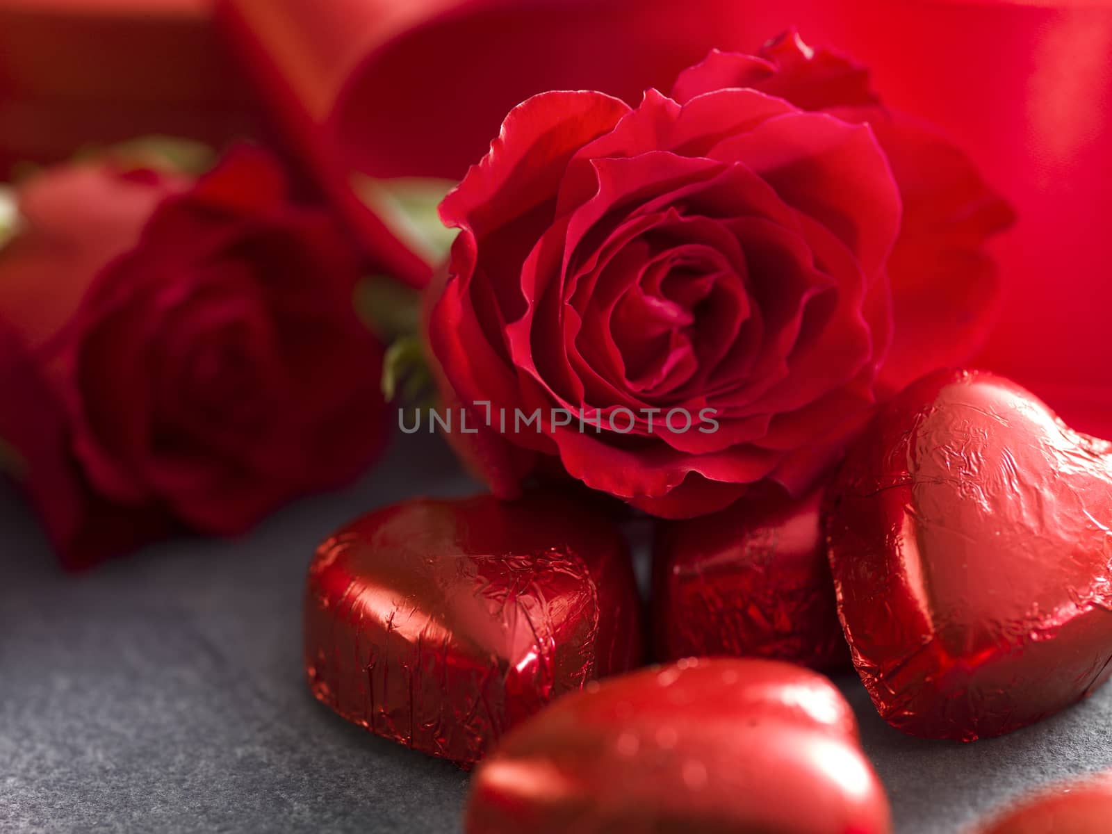 Valentines day background. Close up from chocolate hearts and red roses