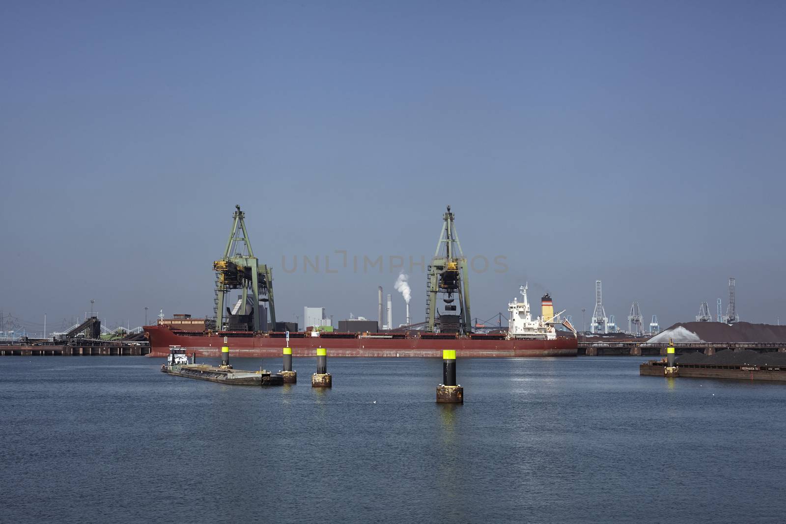 coal industry in the harbor of rotterdam netherlands. Vessel loading coal