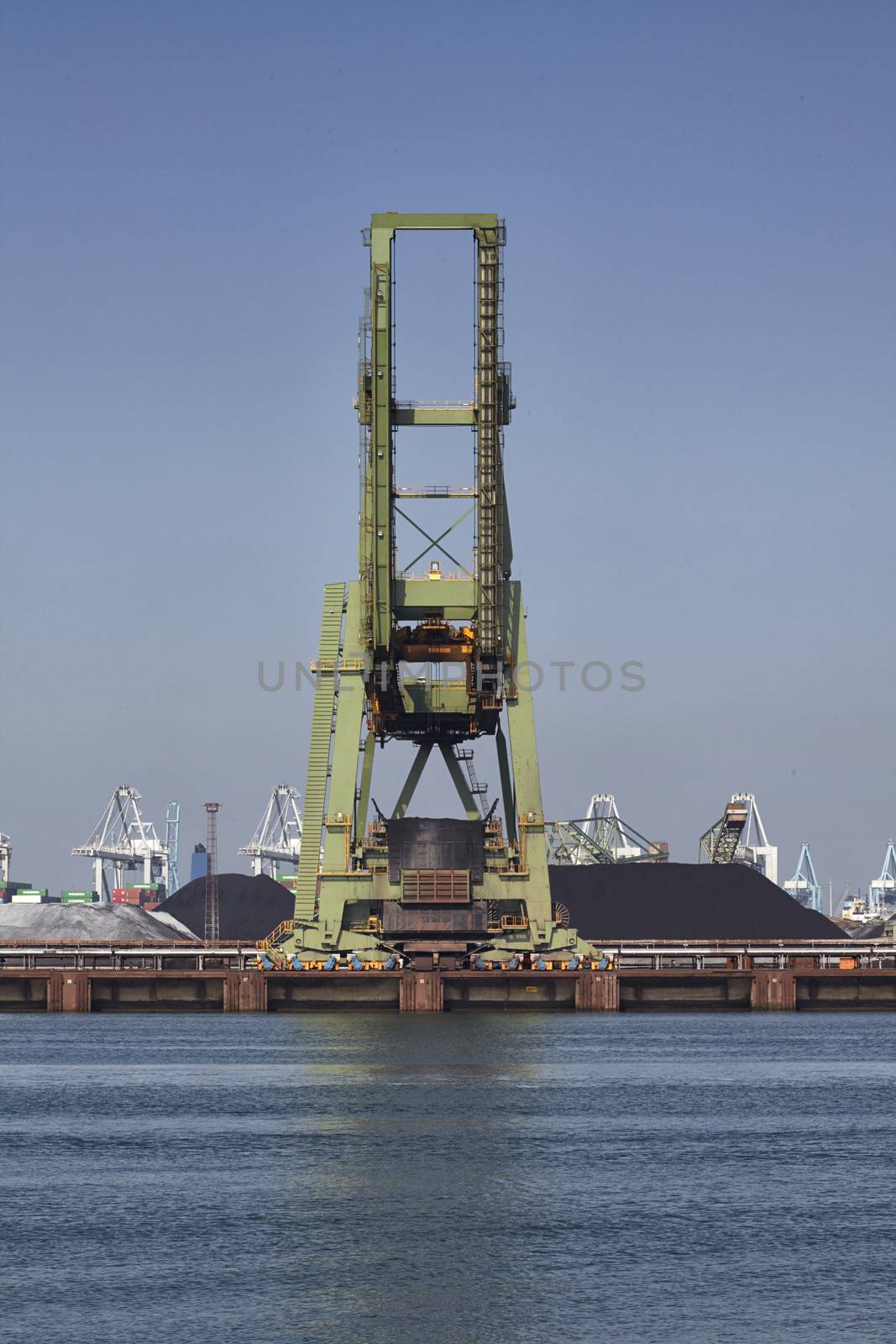 Coal cranes in the harbor of rotterdam by janssenkruseproductions