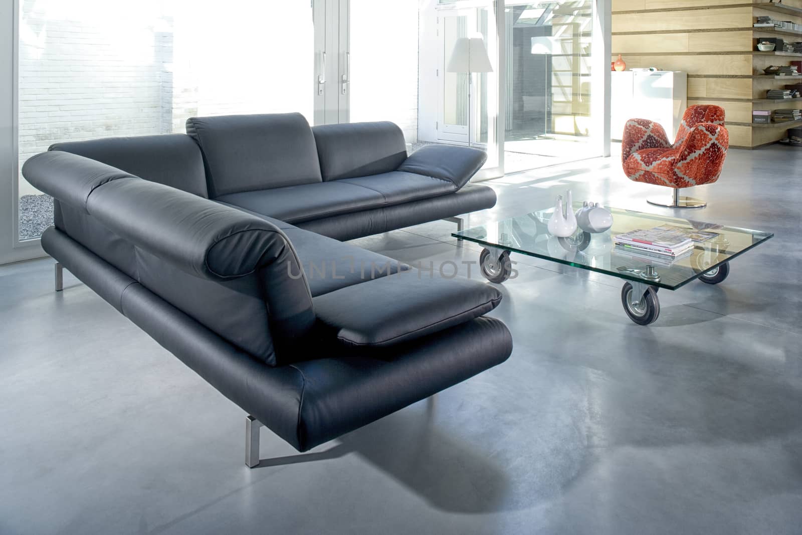 Elegant big lounge with grey comfortable corner sofa in a modern house