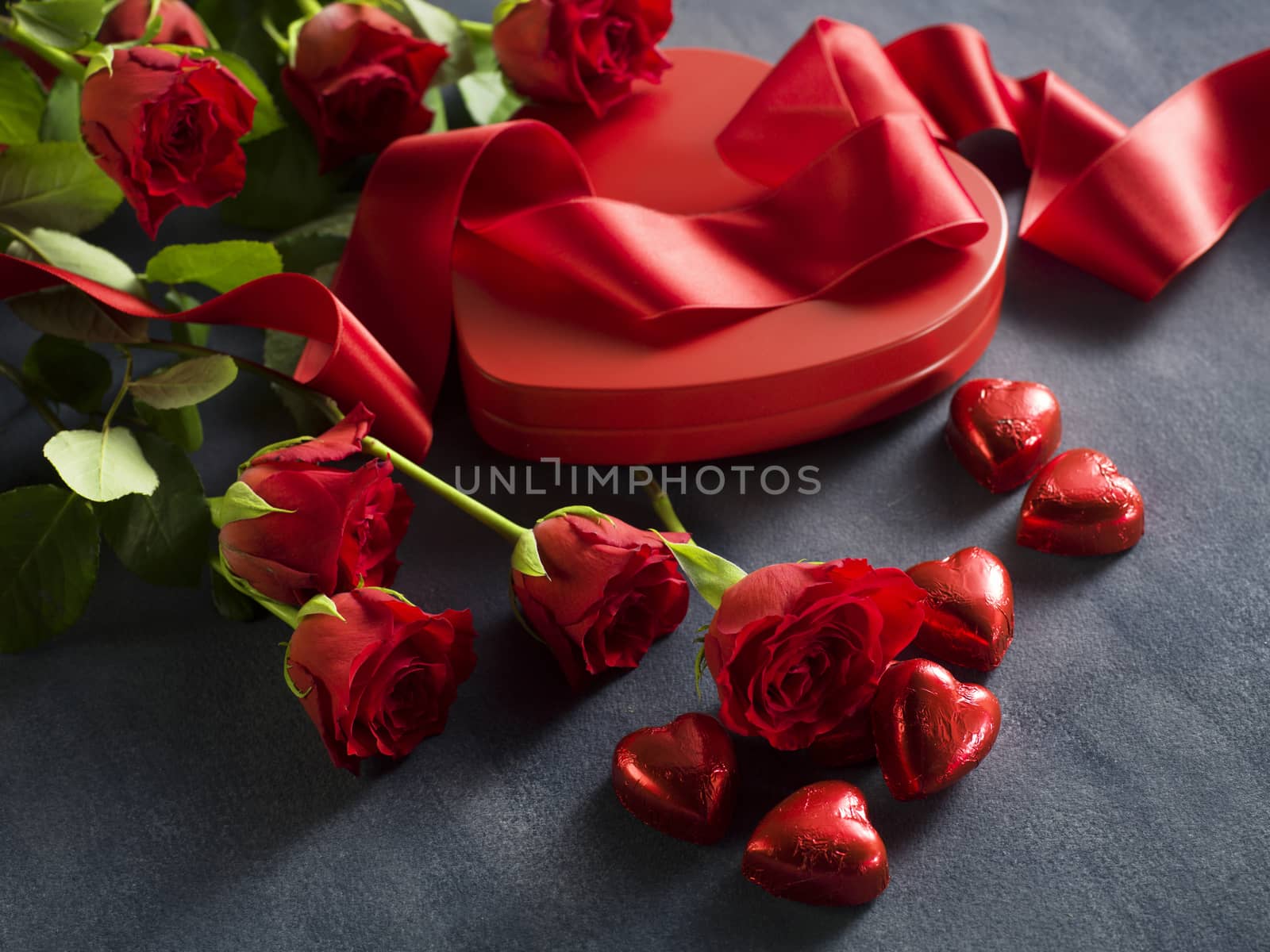 Gift box with red roses and a red ribbon on Valentine's Day