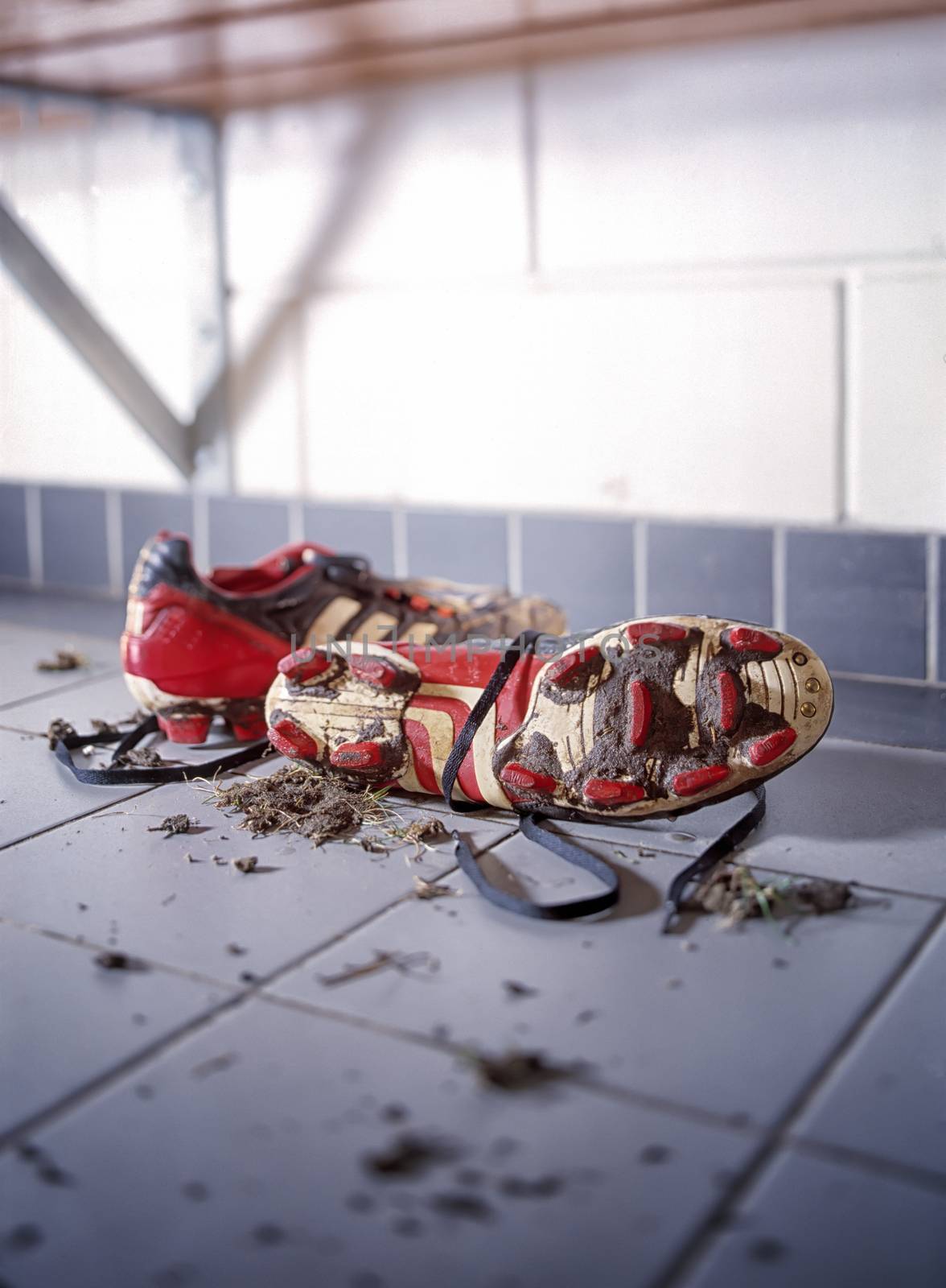 Pair of dirty football shoes by janssenkruseproductions