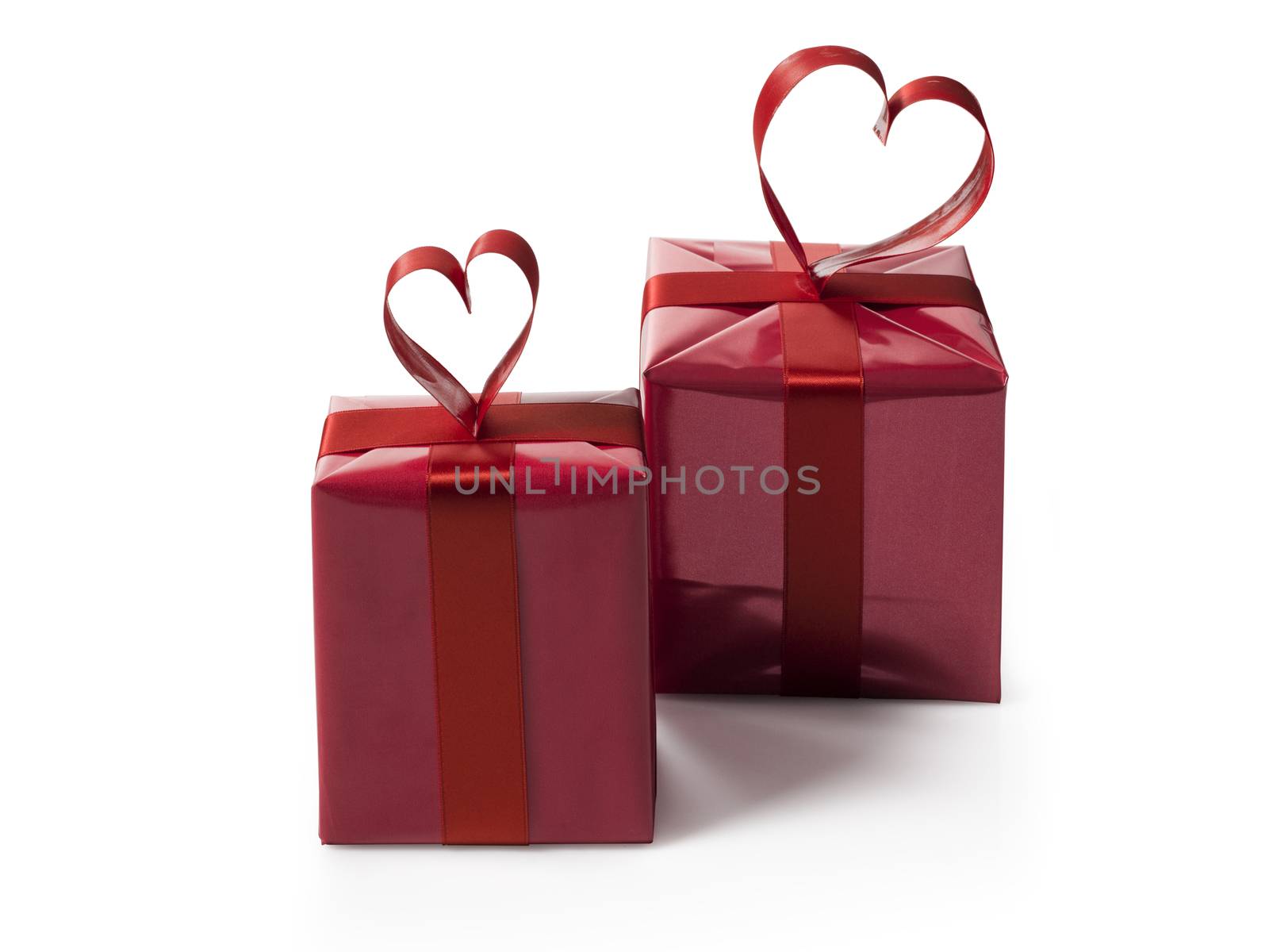 two red gift boxes with red hart shaped ribbon bow by janssenkruseproductions