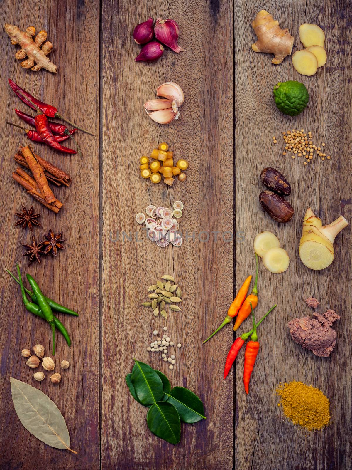 Various of Thai food Cooking ingredients and spice red curry paste ingredient of thai popular food on rustic wooden background. Spices ingredients chilli ,pepper, garlic nutmeg and Kaffir lime leaves.