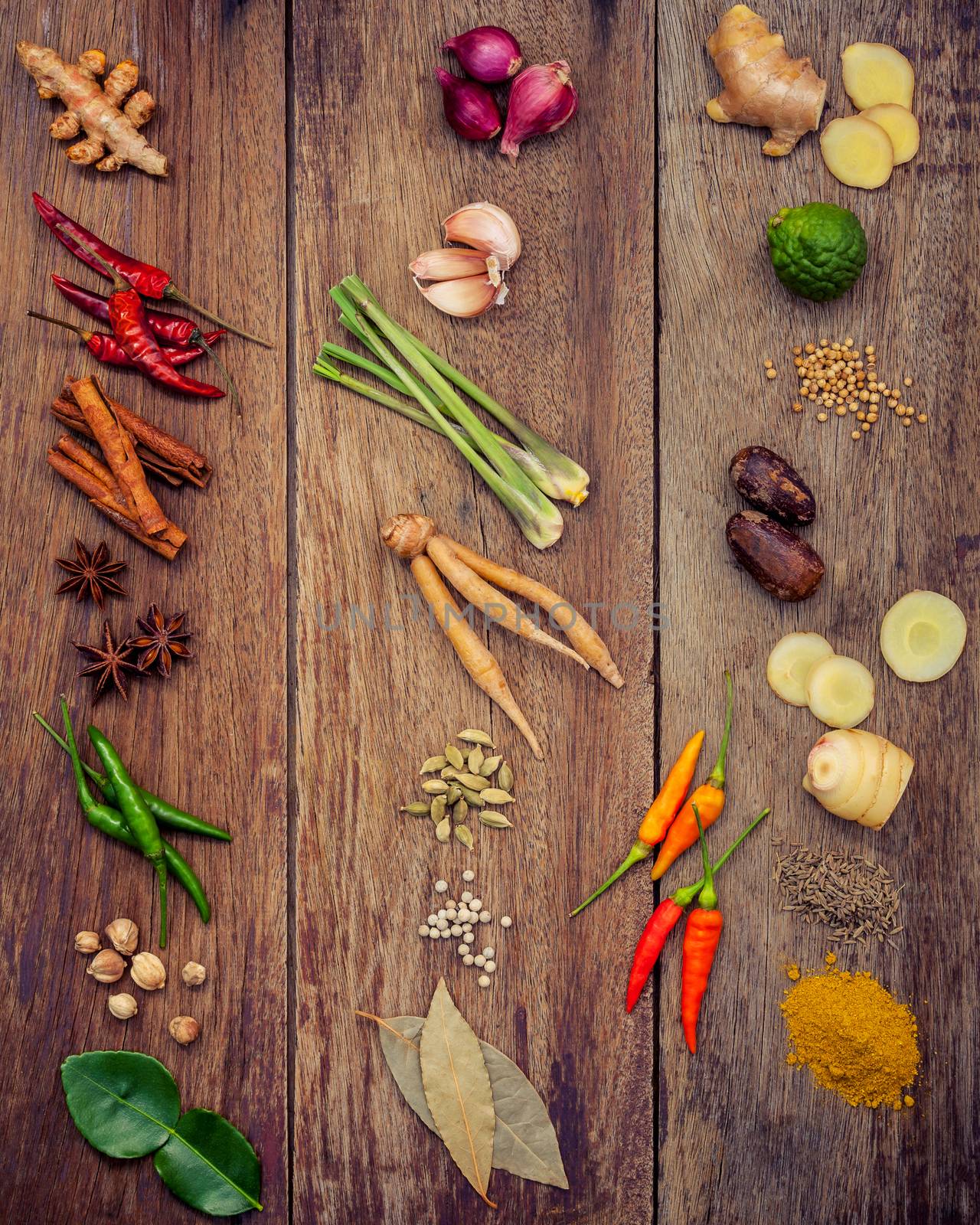 Various of Thai food Cooking ingredients and spice red curry paste ingredient of thai popular food on rustic wooden background. Spices ingredients chilli ,pepper, garlic nutmeg and Kaffir lime leaves.