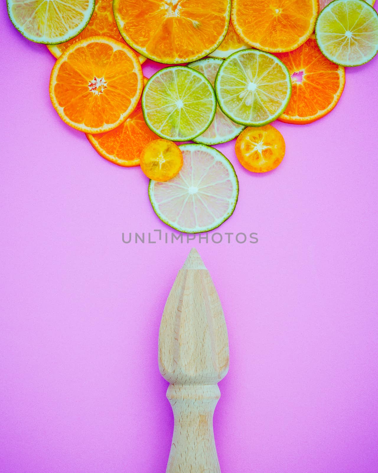 Mixed fresh citrus fruits and wooden juicer for summer citrus ju by kerdkanno