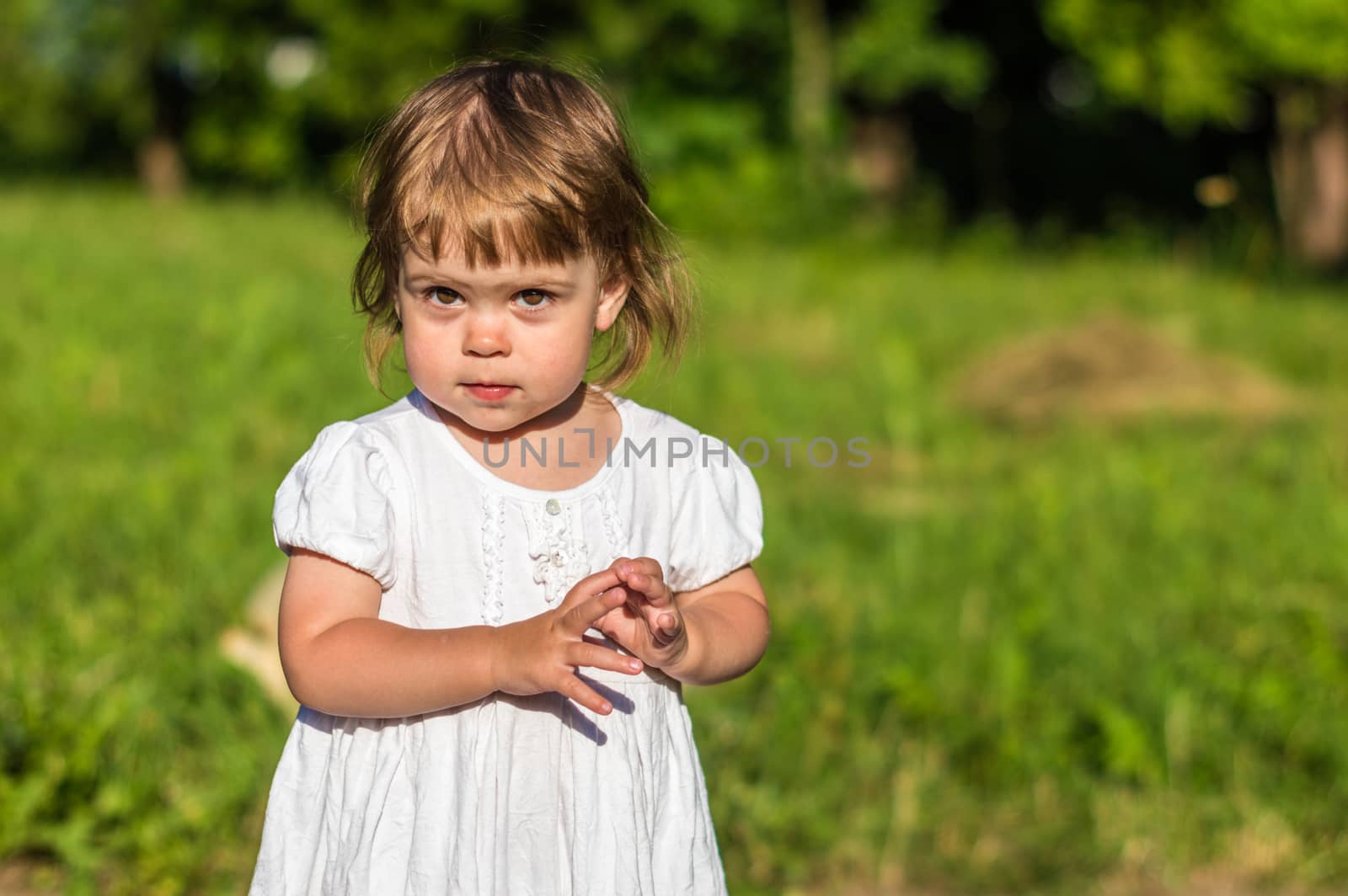 a little girl walks in the Park in summer