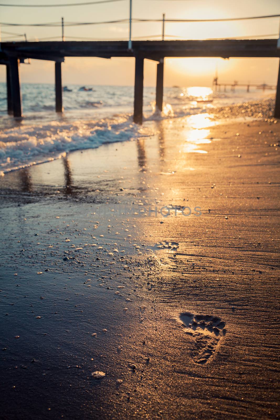 Footprints on the beach in the evening