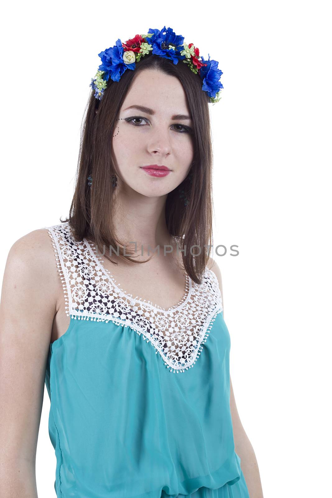 Portrait of a girl in a wreath of flowers on a white background