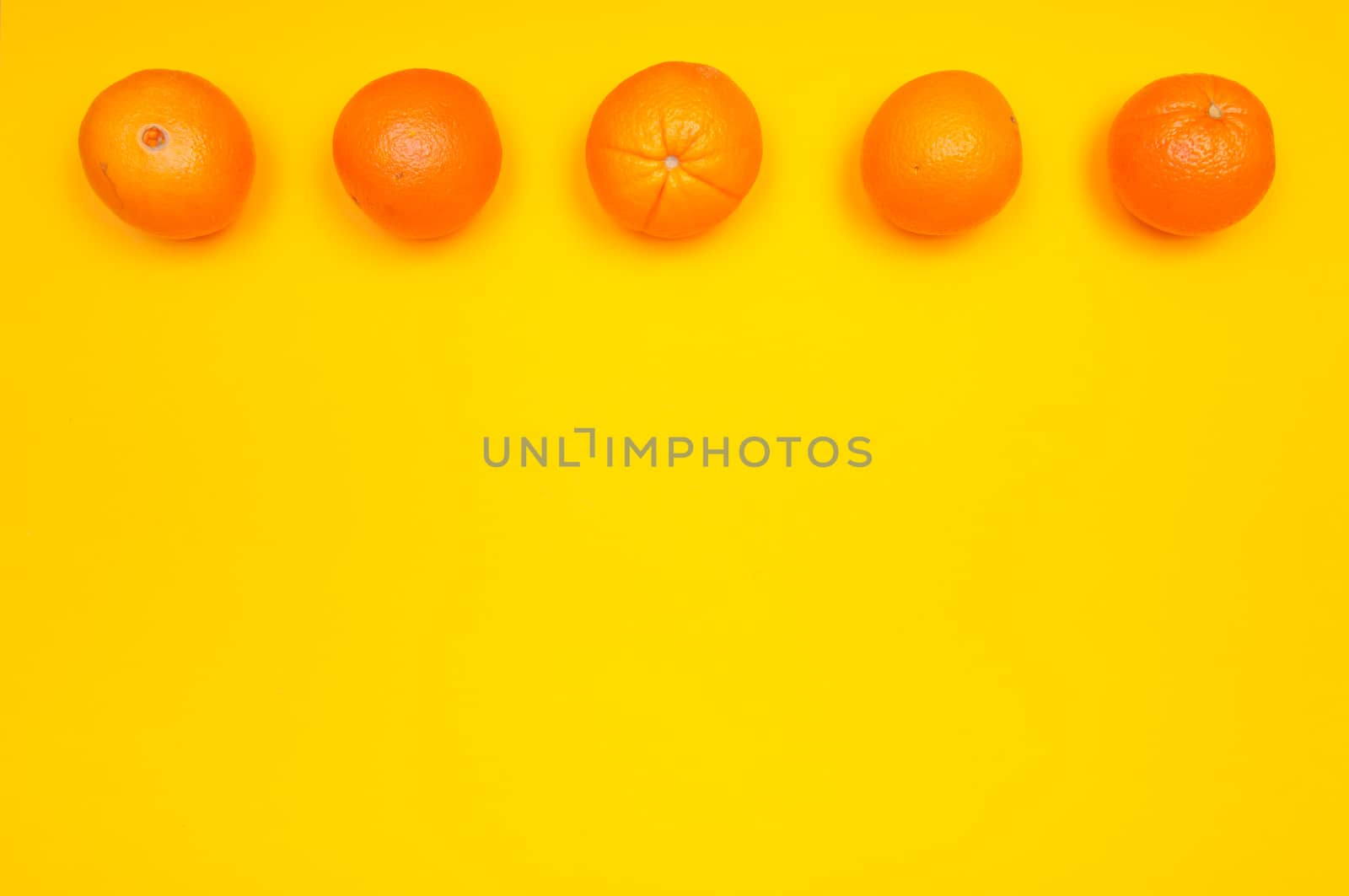 Orange pattern on orange colored background citrus arrangement