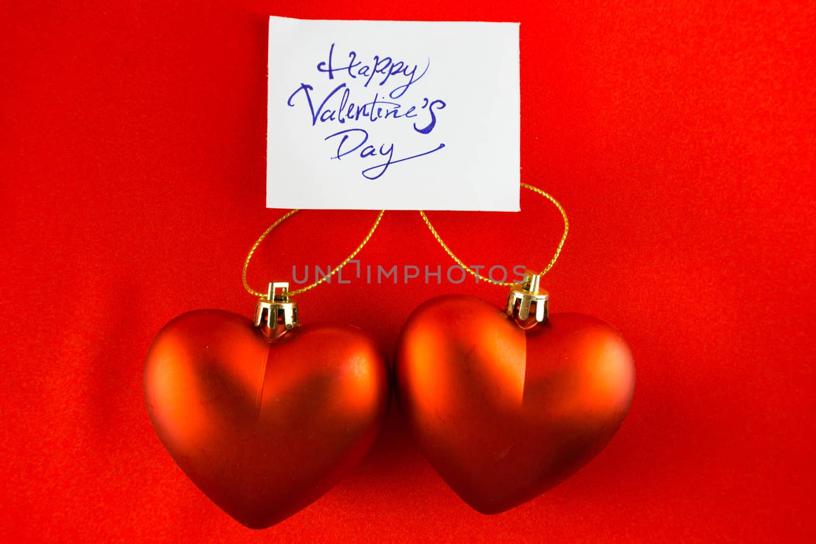 Red heart Valentines with message card on red background Image o by nopparats