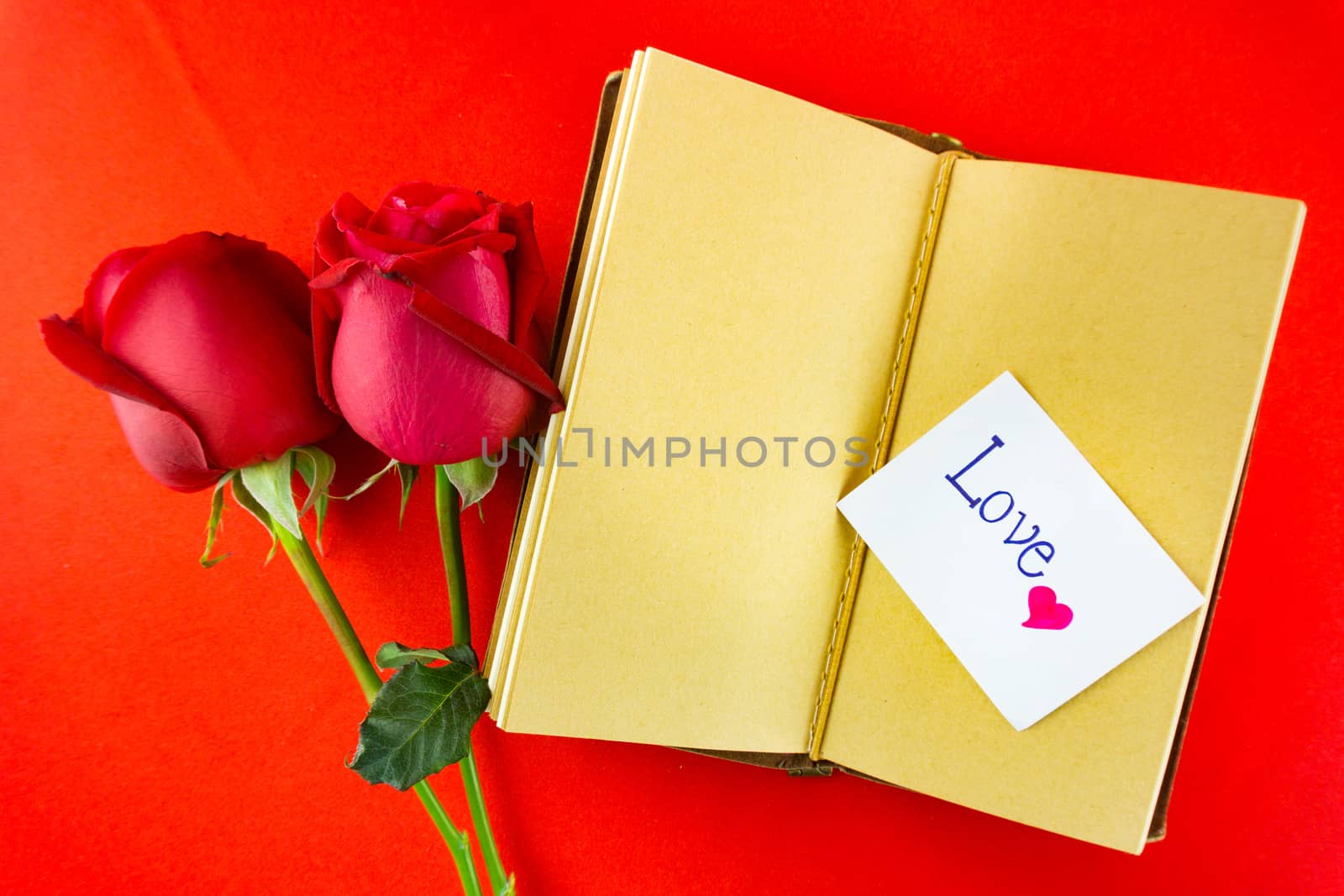 Valentines notebook with message card on red background. Image of Valentines day.