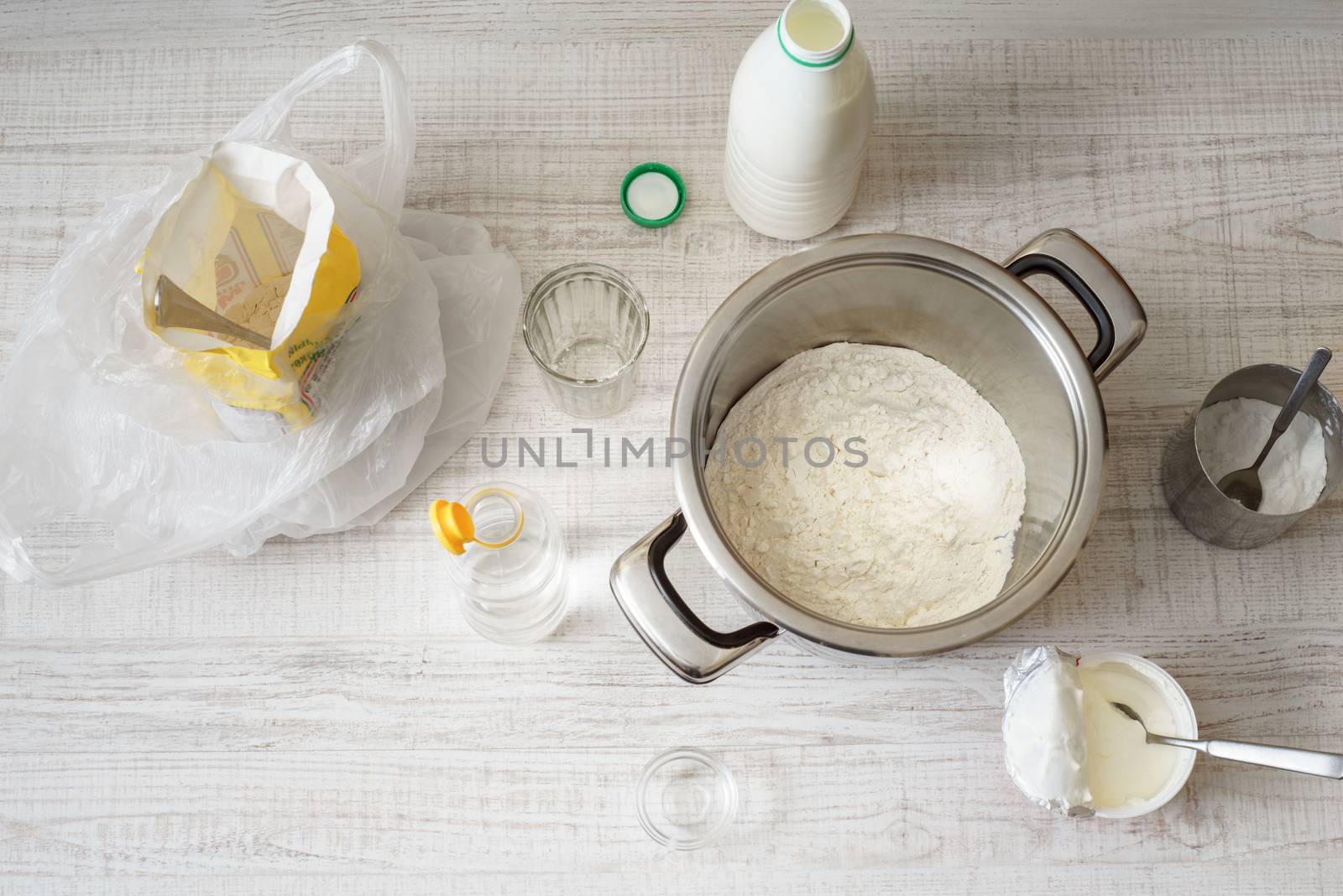 Ingredients for cooking dough pizza on the white table by Deniskarpenkov
