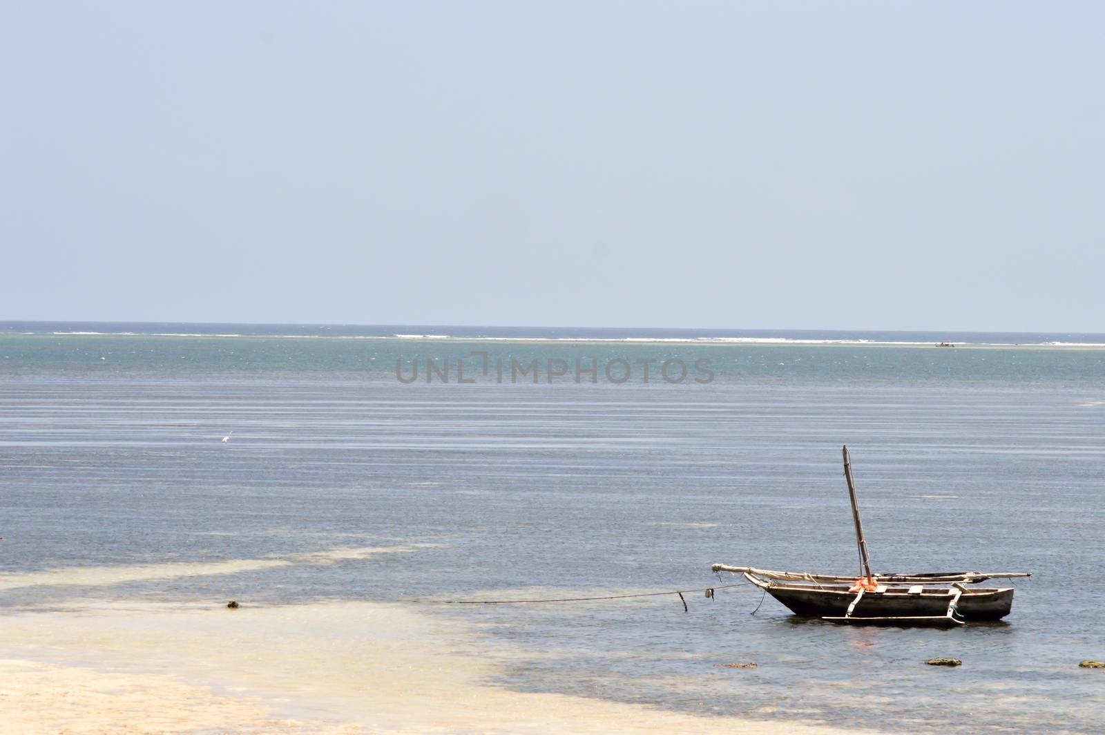 Sail without a sail on the sand during the falling tide on the Indian Ocean