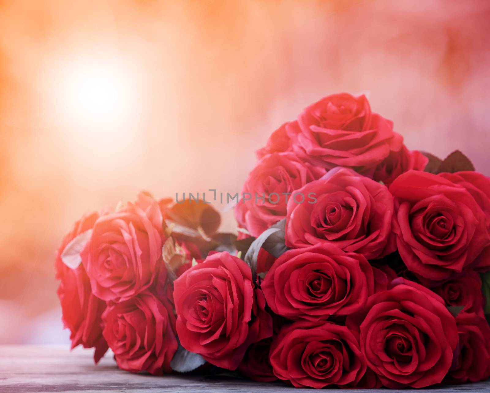 close up beautiful red roses bouguet with glowing light backgrou by khunaspix