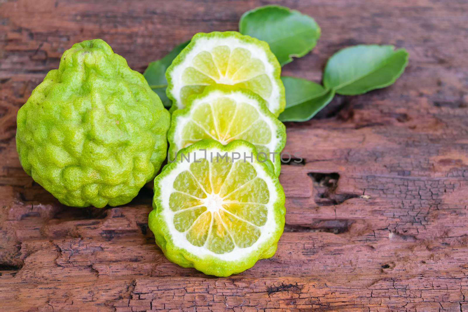 Bergamot on old wooden tables background.