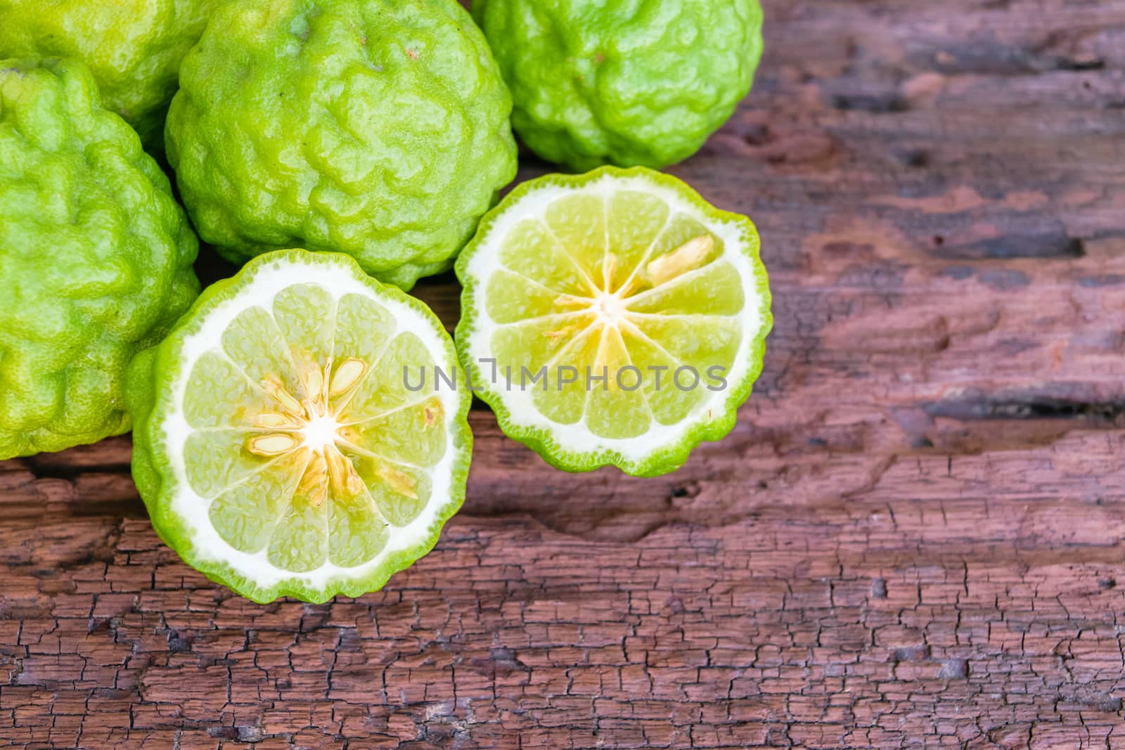 Bergamot on old wooden tables background.