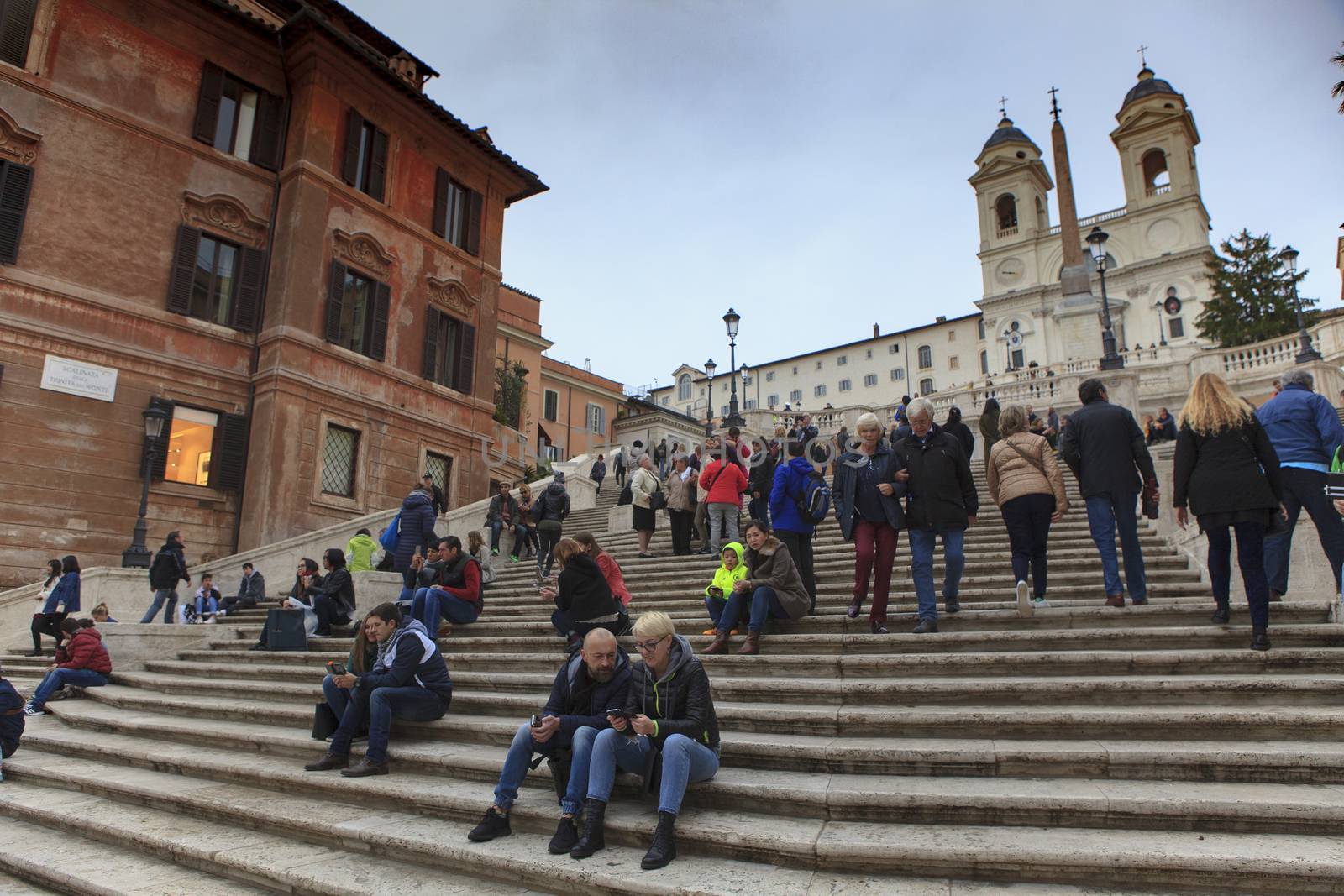 ROME ITALY - NOVEMBER 8 : large number of tourist sitting in front of spanish step fountain important traveling landmark and shopping point on november 8, 2016 in rome italy