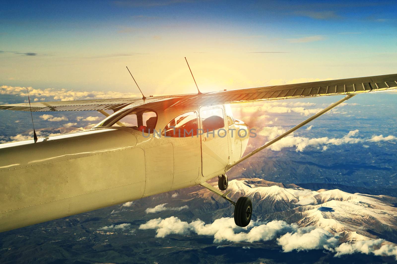 propeller plane flying over high mountain for traveling theme by khunaspix