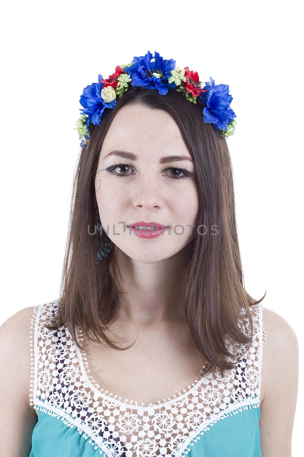 Portrait of a girl in a wreath of flowers on a white background