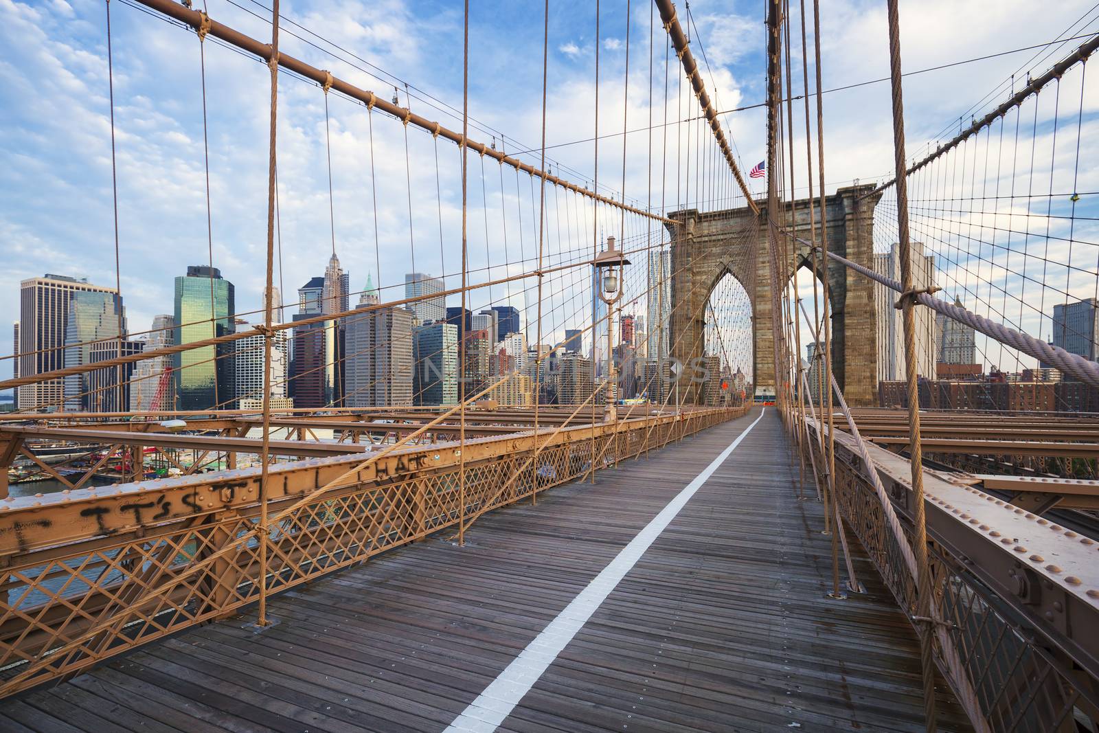 New York City Brooklyn Bridge in Manhattan with skyscrapers and city skyline over Hudson River.