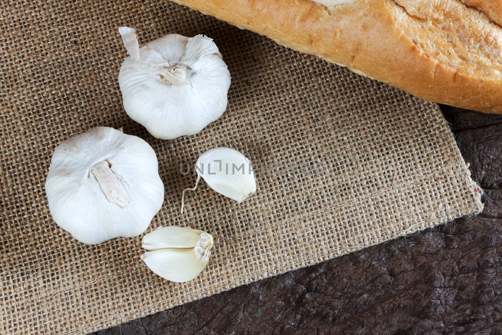 Garlic cloves on a vintage wooden background.