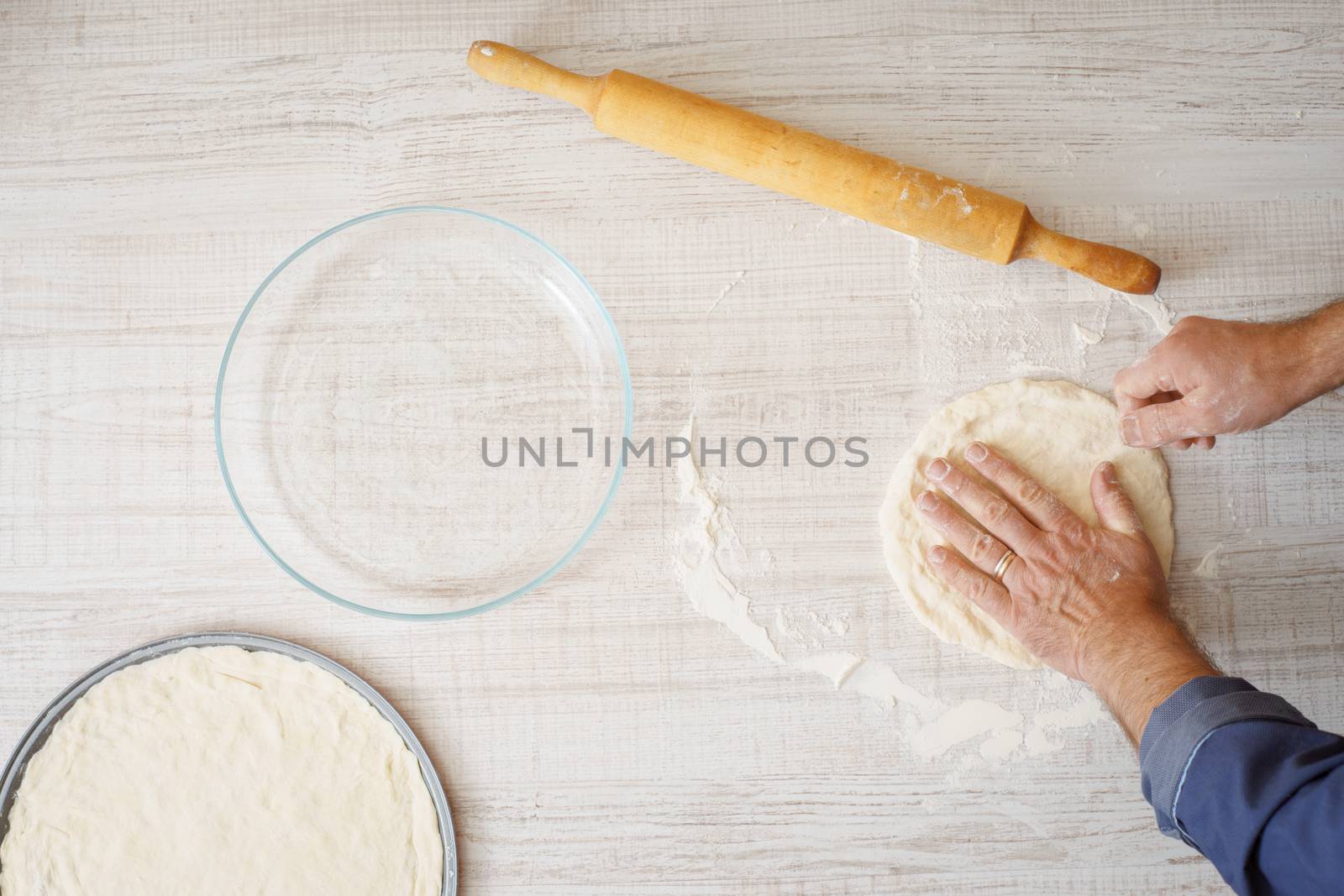 Cooking pizza dough on the wooden table by Deniskarpenkov