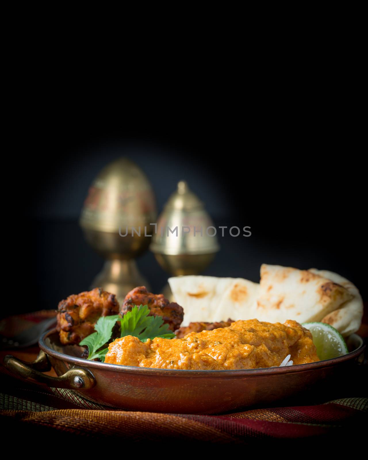 Indian meal consisting of chicken korma, rice, pakoras, and nan bread.
