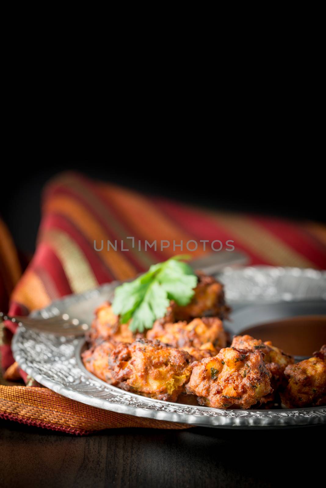 Plate of vegetable Indian palora photographed with selective focus and shallow depth of field.