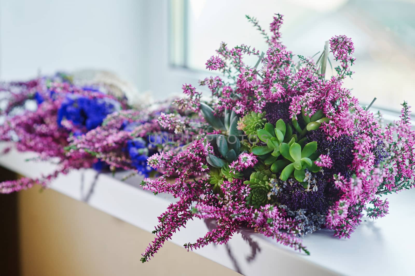 beautiful bridal bouquet on the windowsill in room