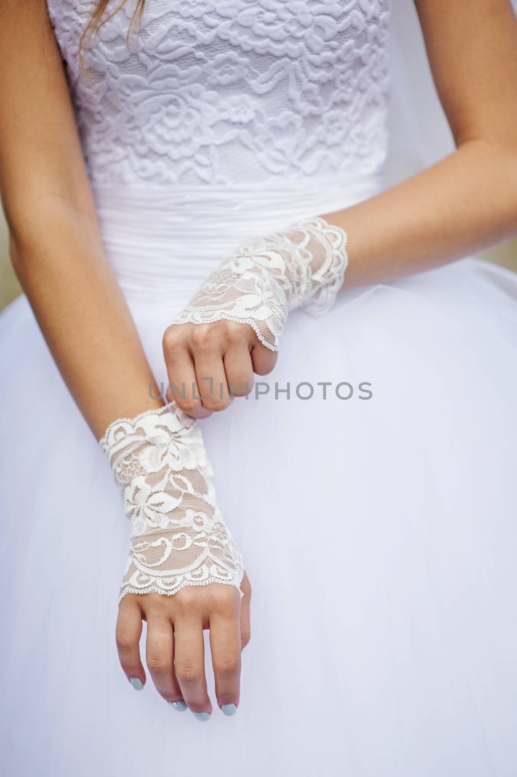 bride in white dress with gloves in wedding day