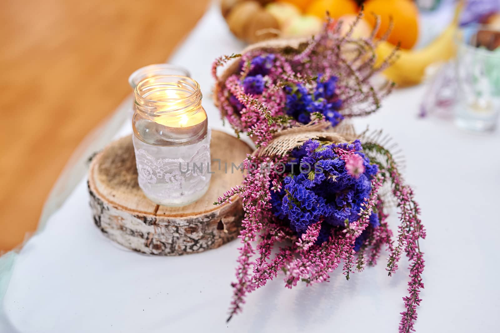 beautiful wedding decor on table with candle and bouquet in rustic style.