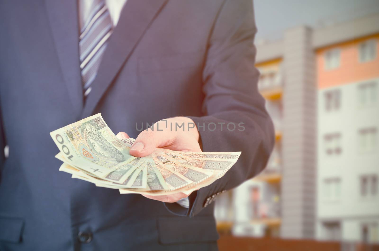 Polish businessman holds money. The loan on the house by simpson33