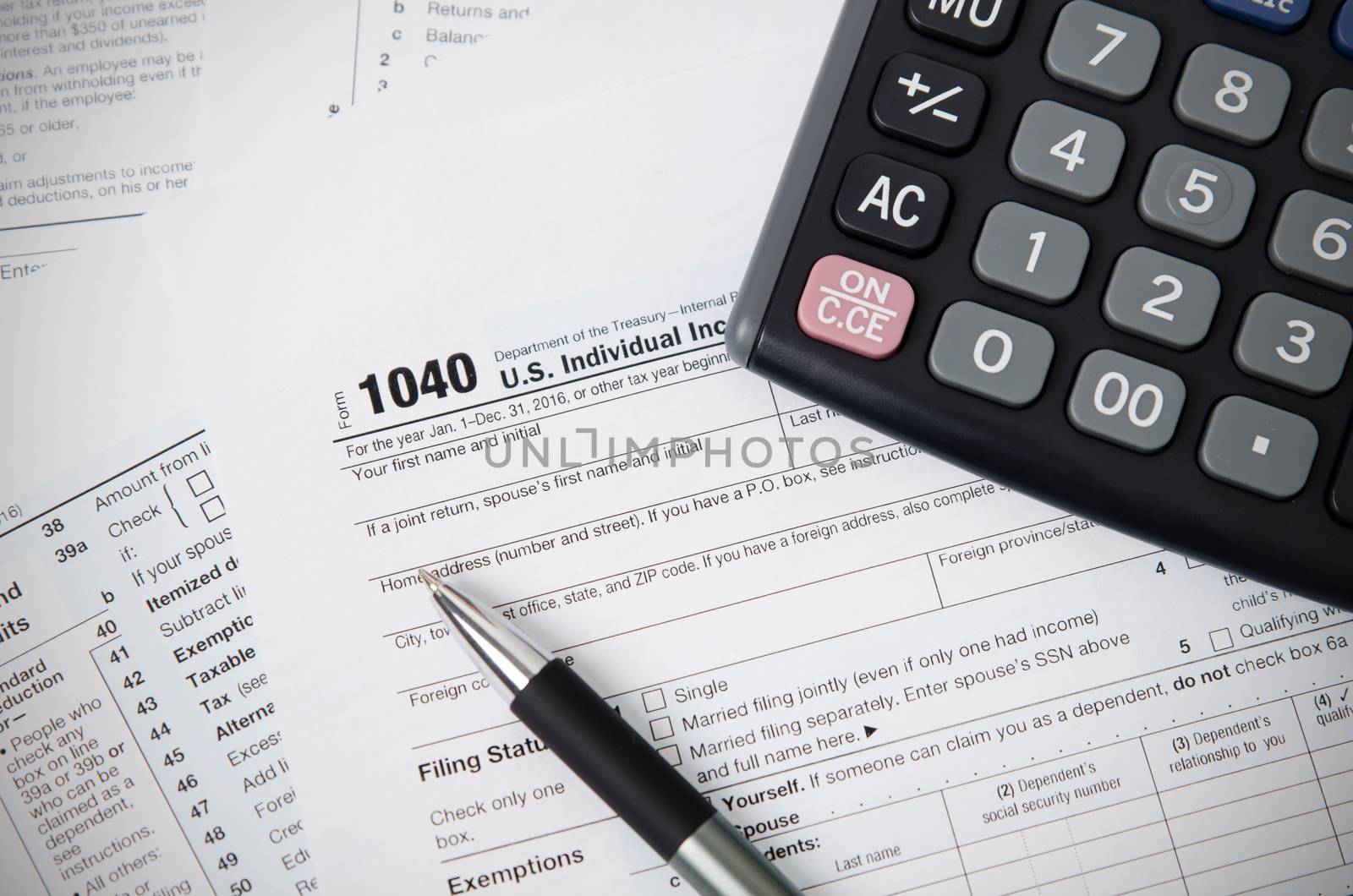 US tax form 1040 with pen and calculator by simpson33