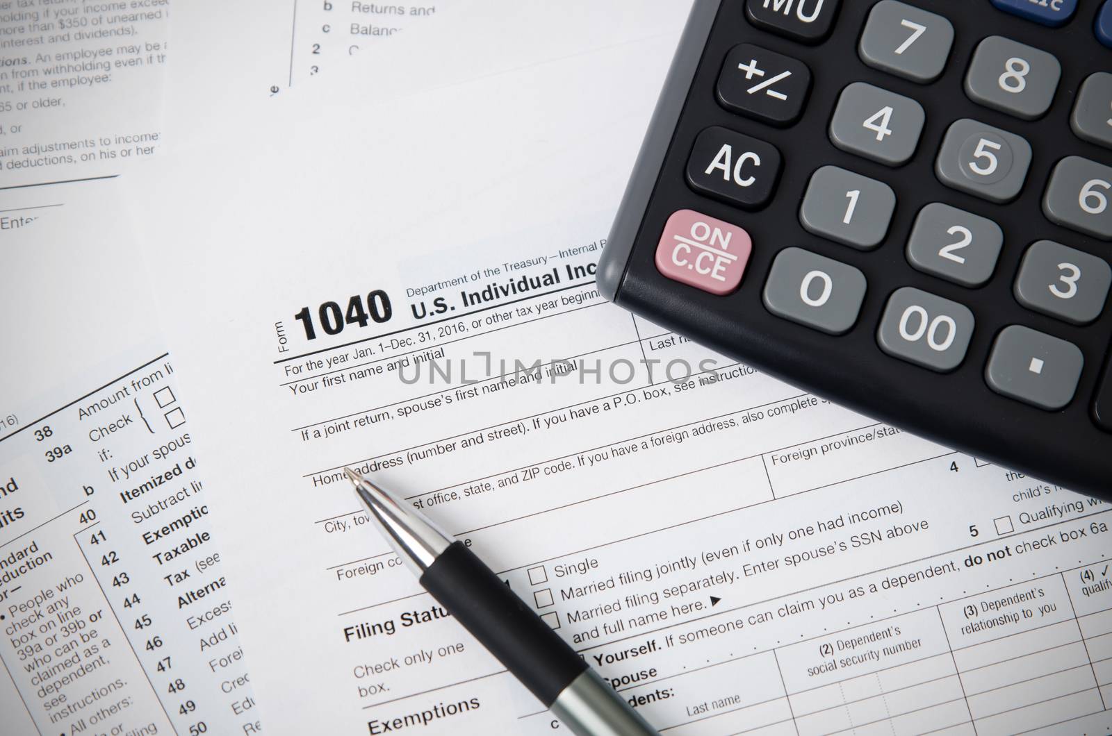 US tax form 1040 with pen and calculator. tax form law document usa white mathematics business concept