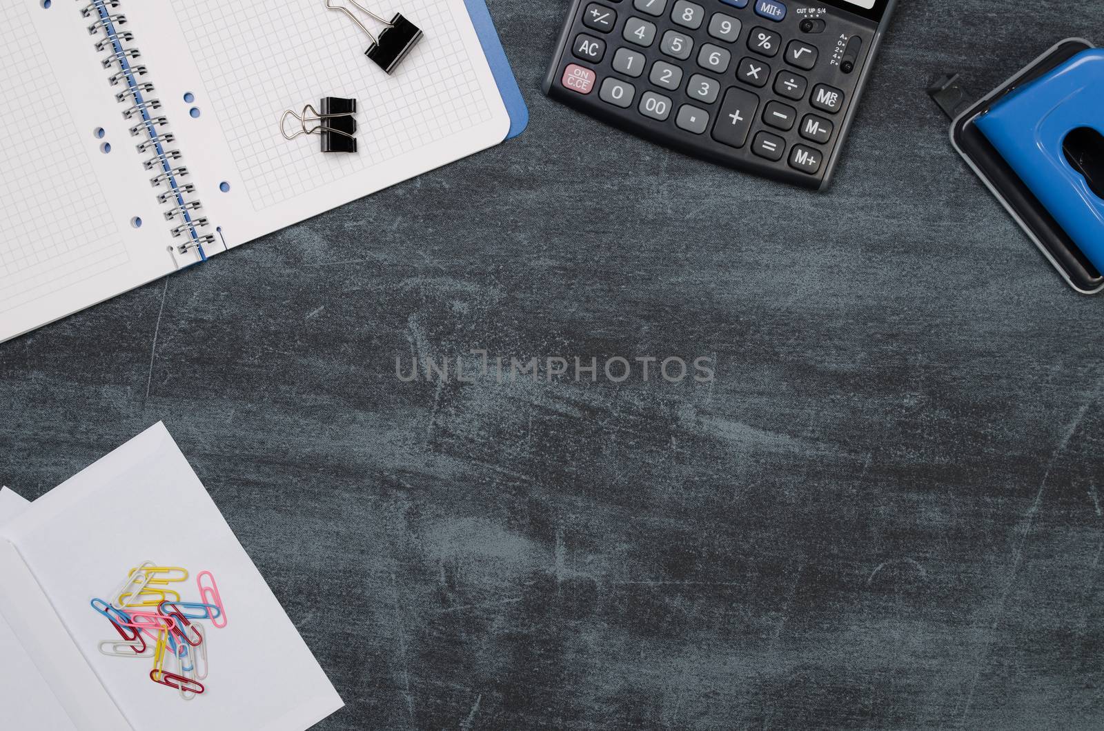 Business desk in office top view. Table with calculator, notepad, and office supplies. Copy space website banner concept